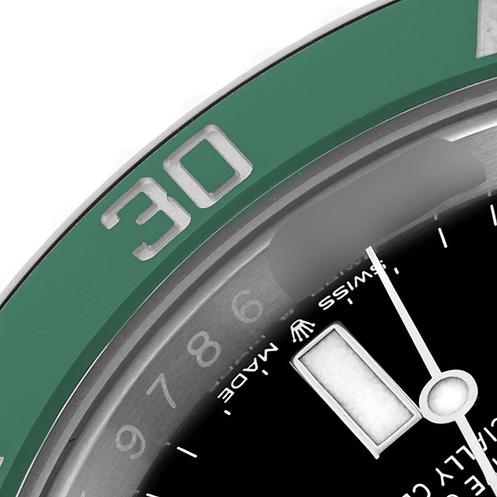 The image shows a close-up of the Rolex Submariner 126610LV Men's Stainless Steel Black Dial 126610LV Men's Stainless Steel Black Dial's green bezel and part of the dial, focusing on the minute markers and inner details.