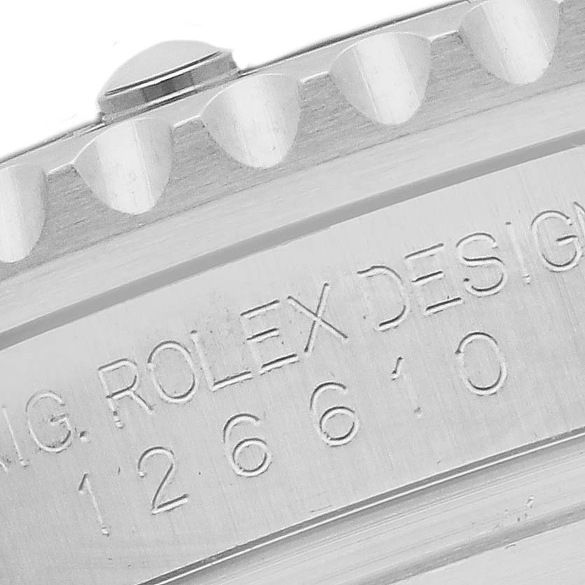 The image shows a side angle of a Rolex Submariner 126610LV Men's Stainless Steel Black Dial 126610LV Men's Stainless Steel Black Dial, focusing on the engraved design number and part of the bezel.