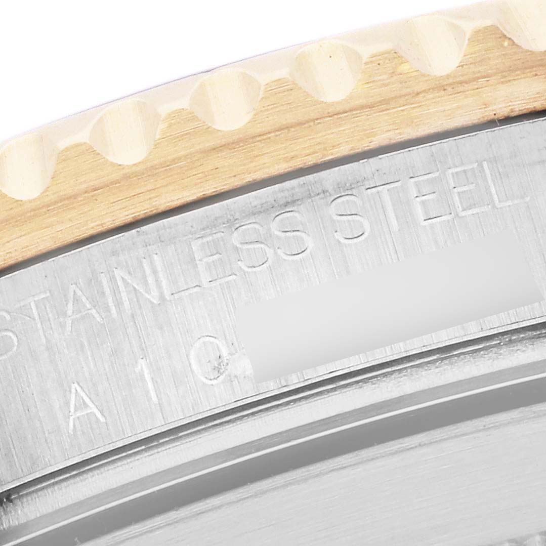 The image shows a close-up of the edge and bezel of a Rolex Submariner 16613 Men's Steel and Gold (two tone) Black Dial 16613 Men's Steel and Gold (two tone) Black Dial, highlighting the stainless steel and engraving.