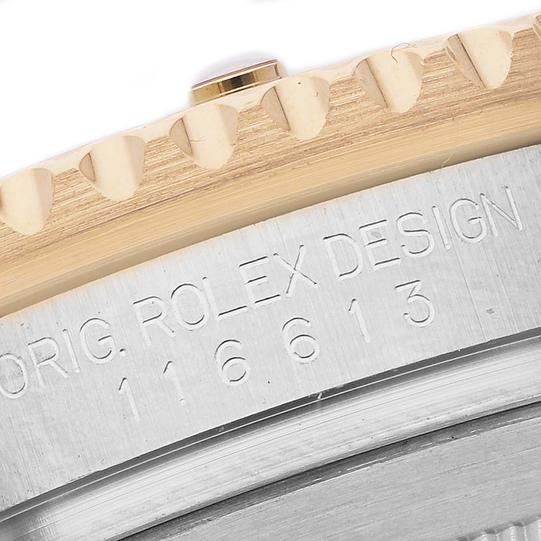 The image shows a close-up of the bezel and case edge of a Rolex Submariner 116613 Men's Steel and Gold (two tone) Blue Dial, highlighting the engraving.