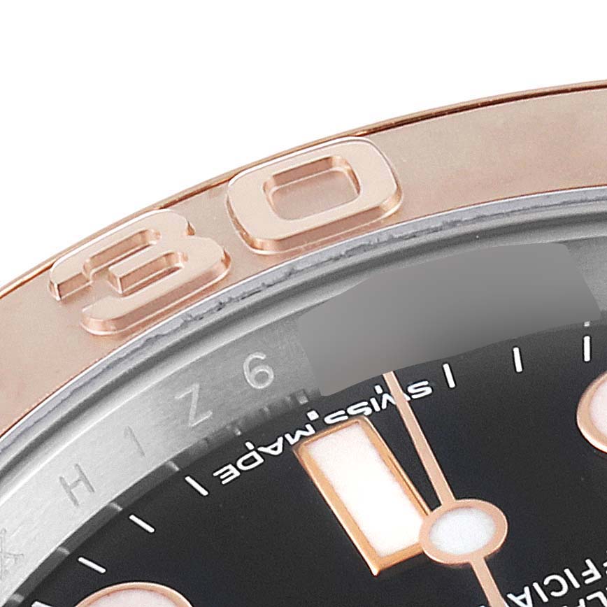 This image shows a close-up of the bezel and dial of a Rolex Yacht-Master 116621 Men
s Steel and Gold (two tone) Black Dial 116621 Men
s Steel and Gold (two tone) Black Dial watch, highlighting the 30-minute marker.