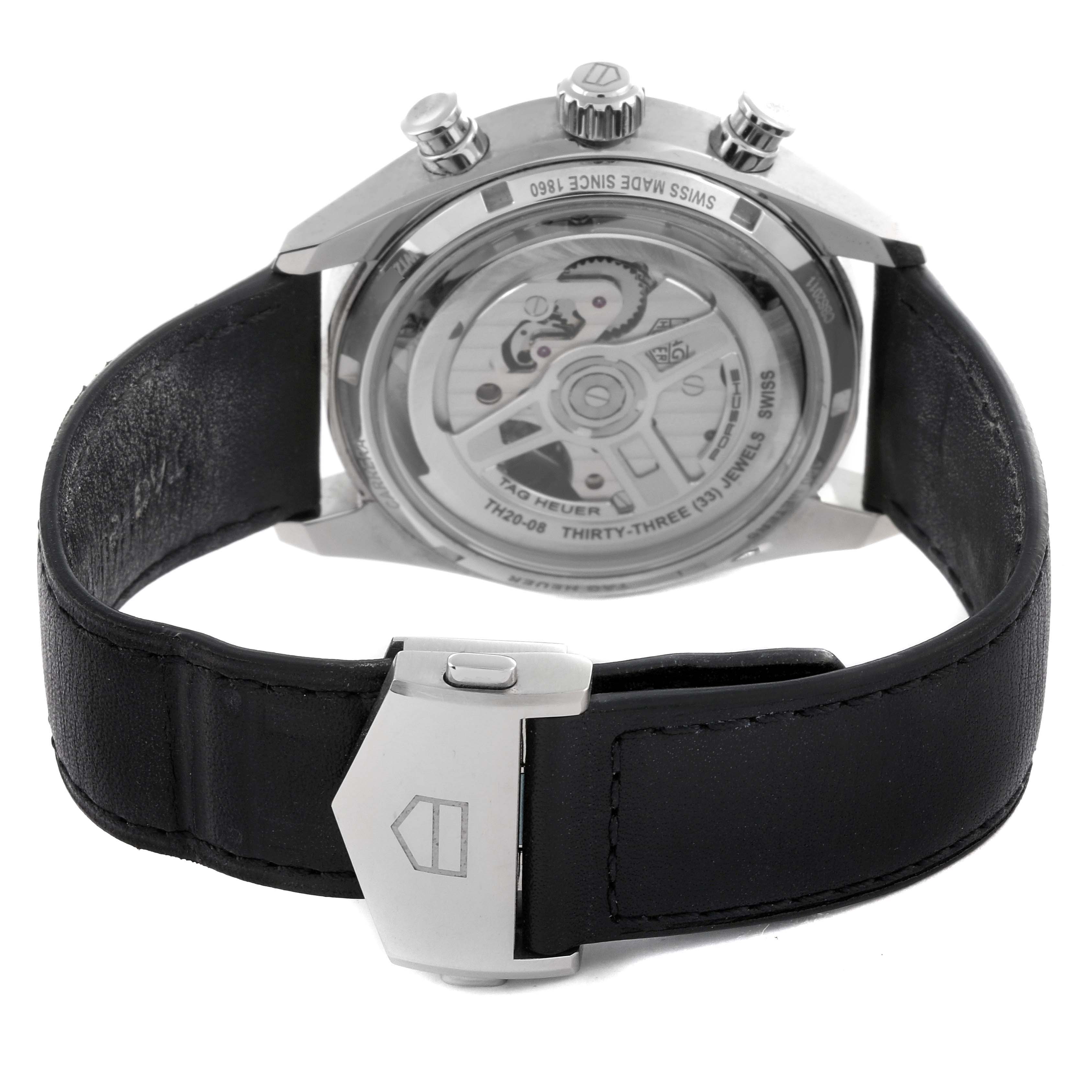 The image shows the back view of a Tag Heuer Carrera CBS2011.FC6529 Men's Stainless Steel Silver Dial CBS2011.FC6529 Men's Stainless Steel Silver Dial watch, highlighting its transparent case back and black leather strap with a clasp.