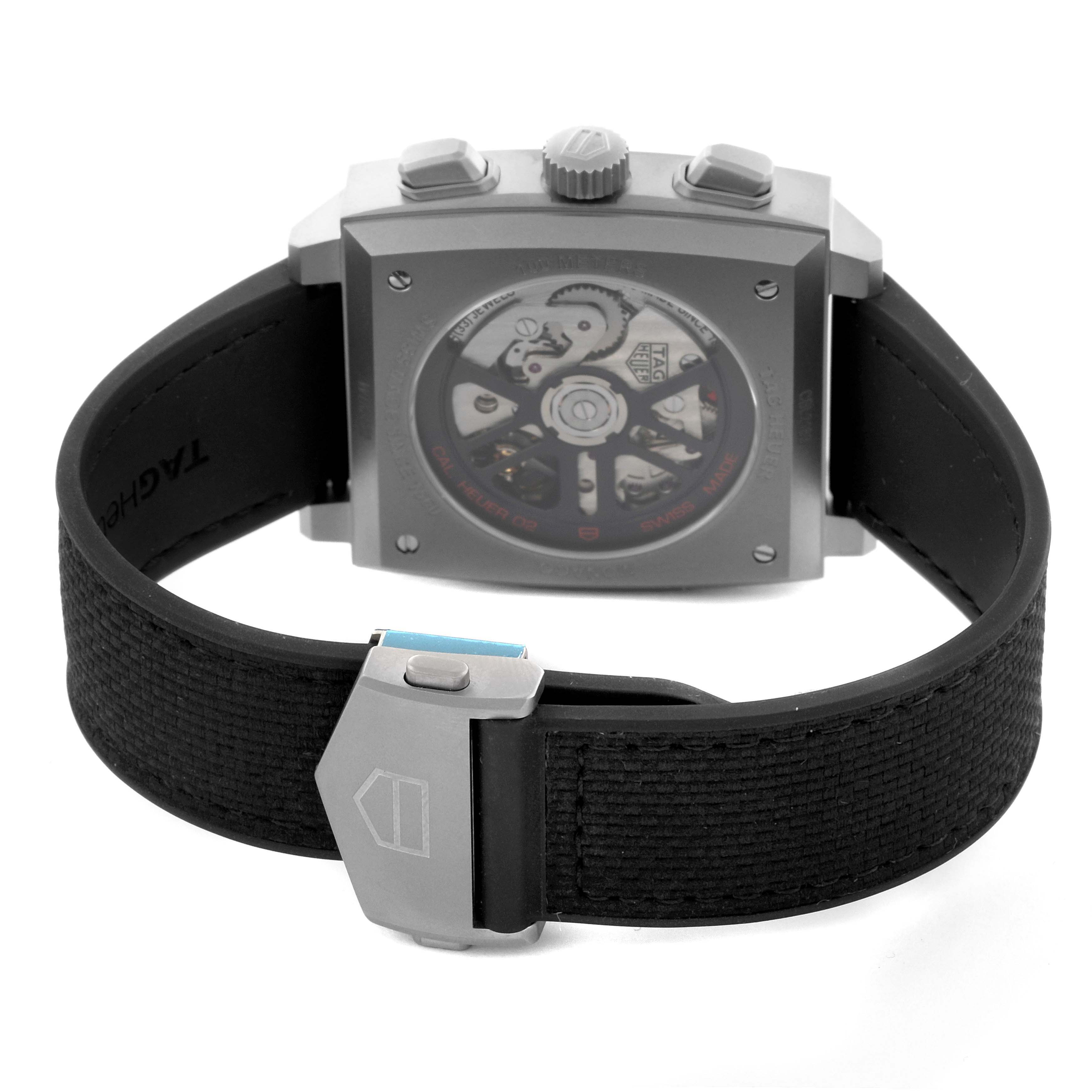 The image shows the back view of the Tag Heuer Monaco CBL2183.FT6236 Men's Titanium Black Dial CBL2183.FT6236 Men's Titanium Black Dial watch, highlighting the movement and clasp on the strap.