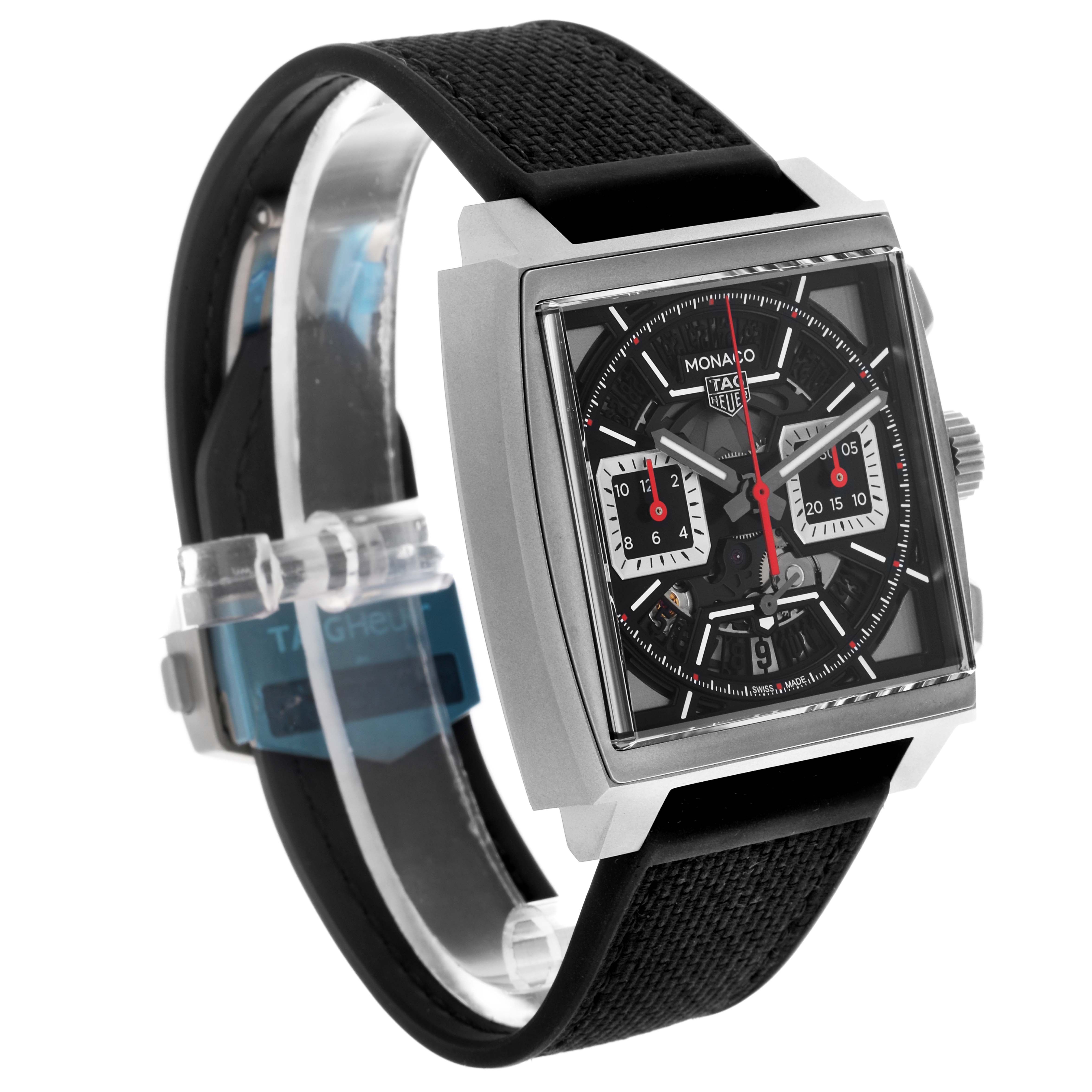 The Tag Heuer Monaco CBL2183.FT6236 Men's Titanium Black Dial CBL2183.FT6236 Men's Titanium Black Dial watch is shown at a slight angle, featuring its rectangular case, black dial with red accents, and black strap.