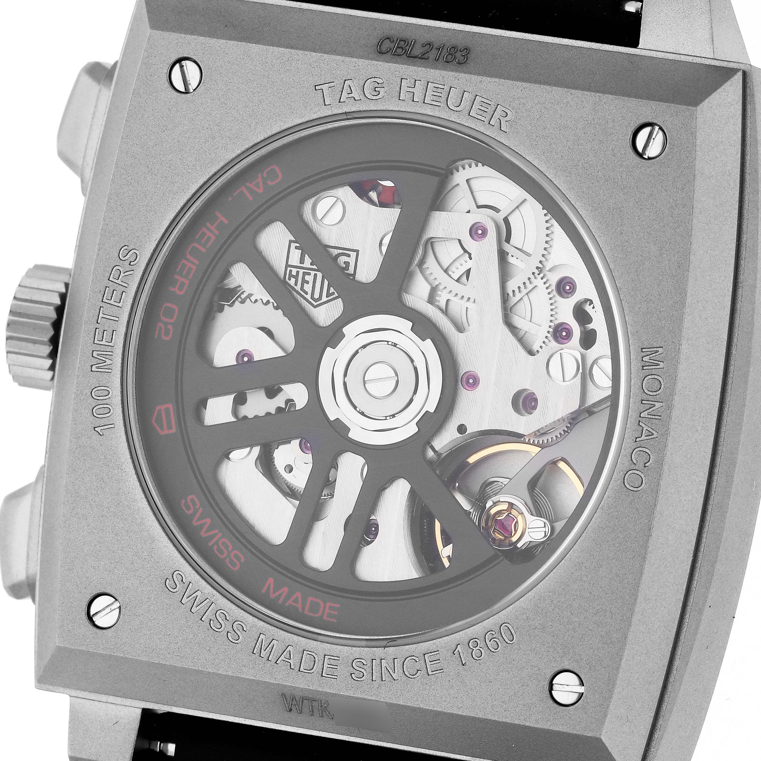 The image shows the back view of the Tag Heuer Monaco CBL2183.FT6236 Men's Titanium Black Dial CBL2183.FT6236 Men's Titanium Black Dial model, highlighting its intricate movement and transparent case back.
