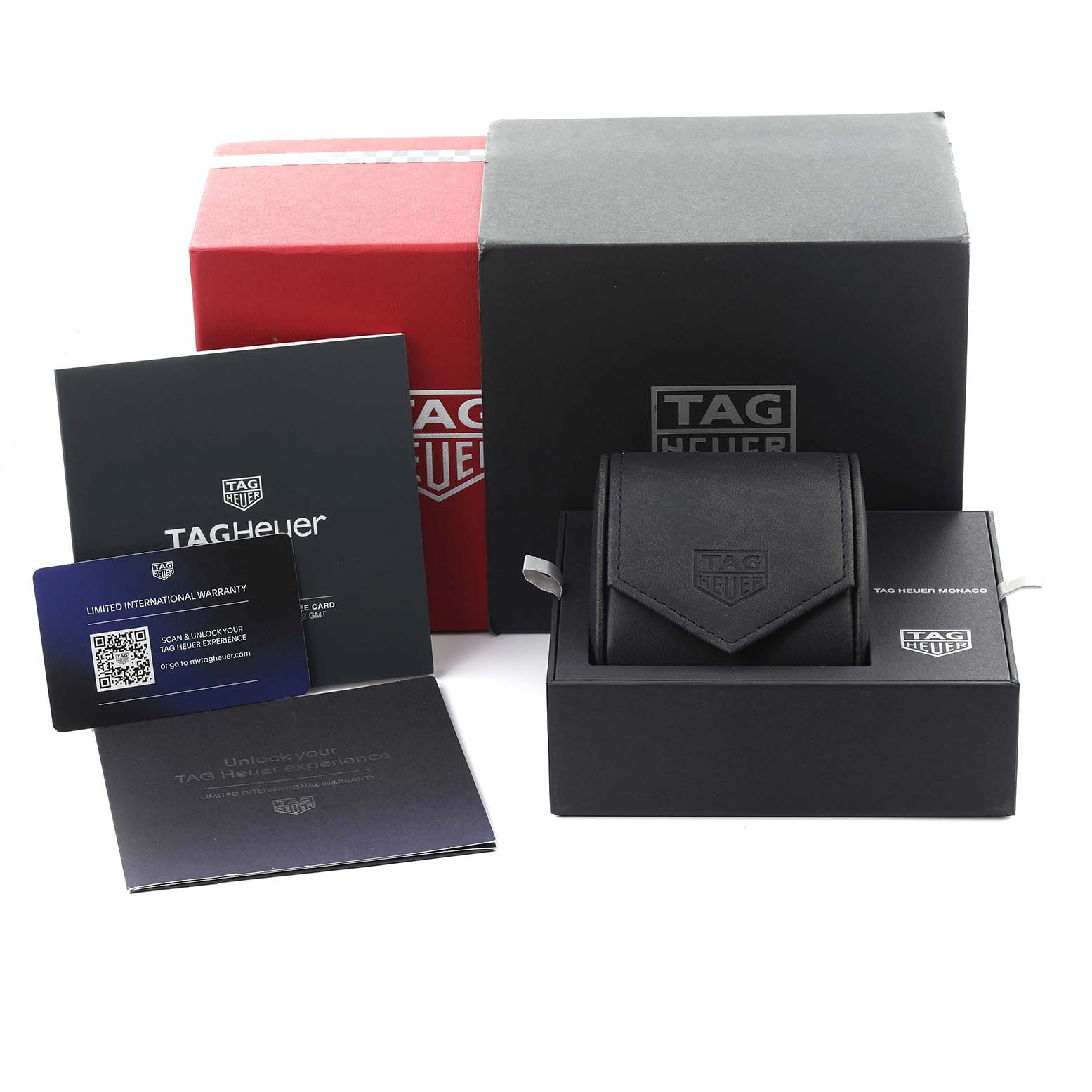 The image shows the packaging and accessories for a Tag Heuer Monaco CBL2183.FT6236 Men's Titanium Black Dial CBL2183.FT6236 Men's Titanium Black Dial watch, including boxes, a warranty card, and manuals.
