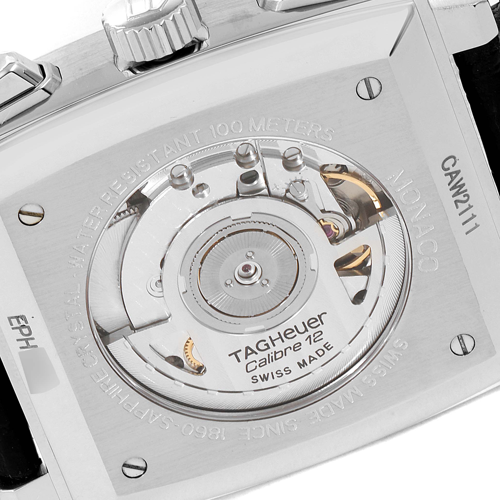 The image shows the back of a Tag Heuer Monaco CAW2111 Men's Stainless Steel Blue Dial CAW2111 Men's Stainless Steel Blue Dial watch, focusing on its Calibre 12 movement.