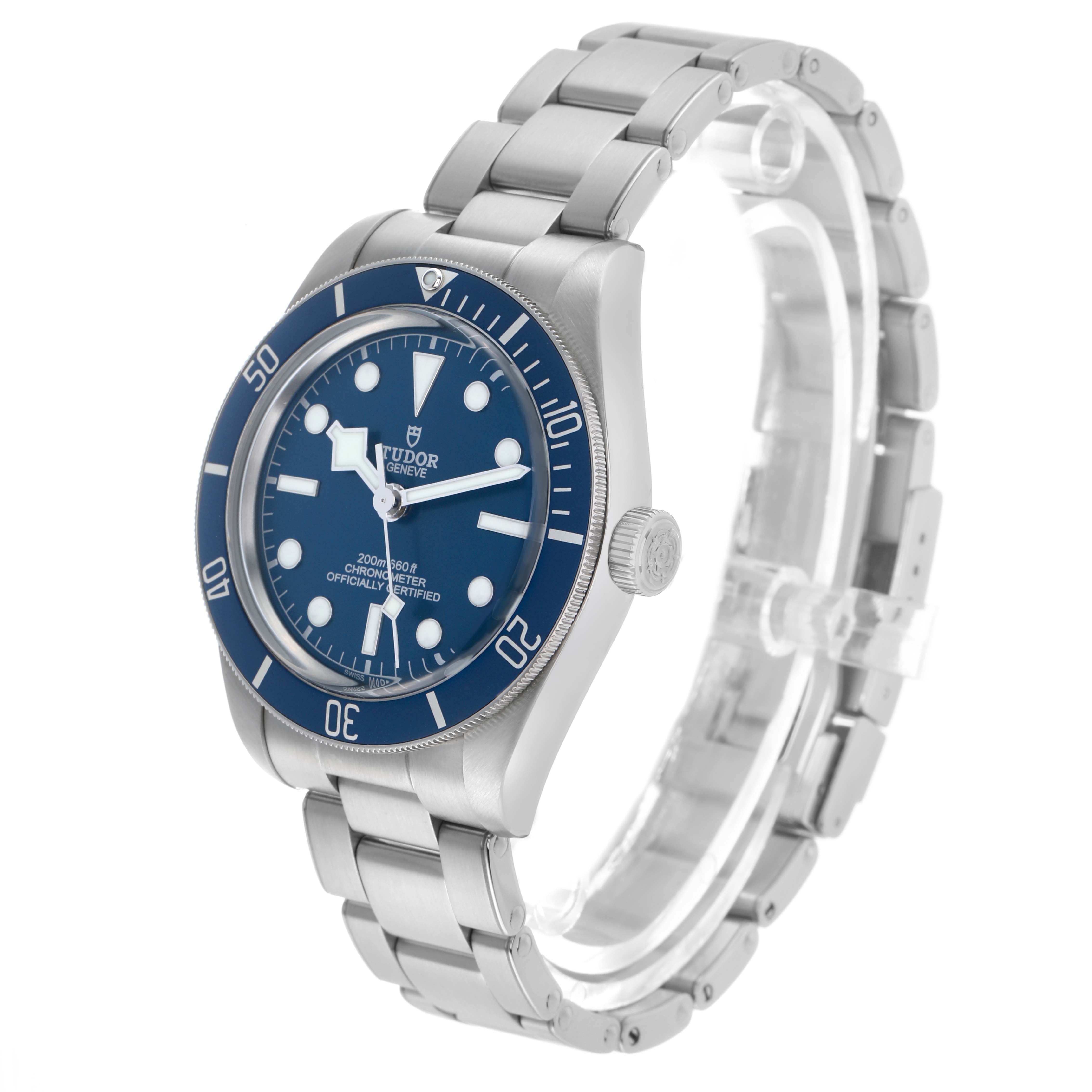 The Tudor Heritage Black Bay 79030B Men's Stainless Steel Blue Dial watch is shown at a three-quarter angle, displaying its face, bezel, crown, and bracelet.