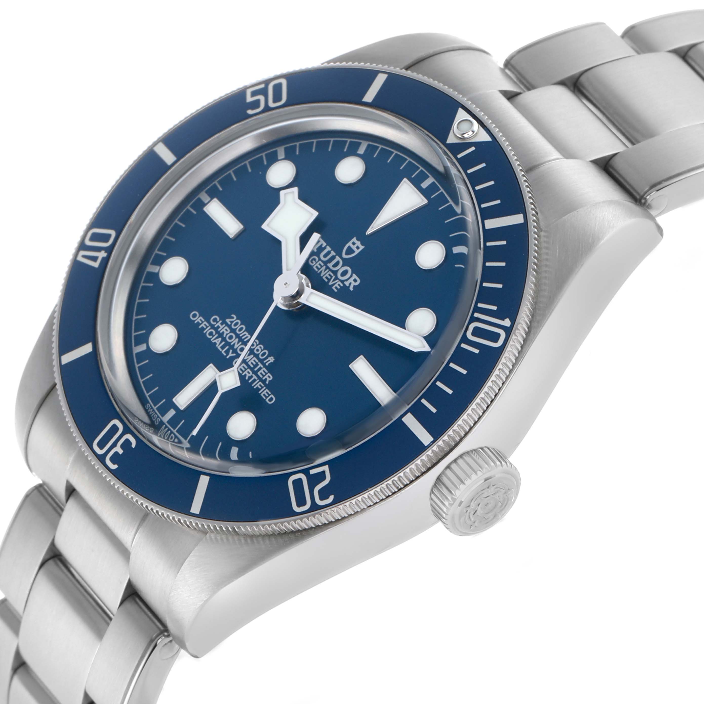 The Tudor Heritage Black Bay 79030B Men's Stainless Steel Blue Dial watch is shown at an angle highlighting the bezel, dial, crown, and a portion of the bracelet.