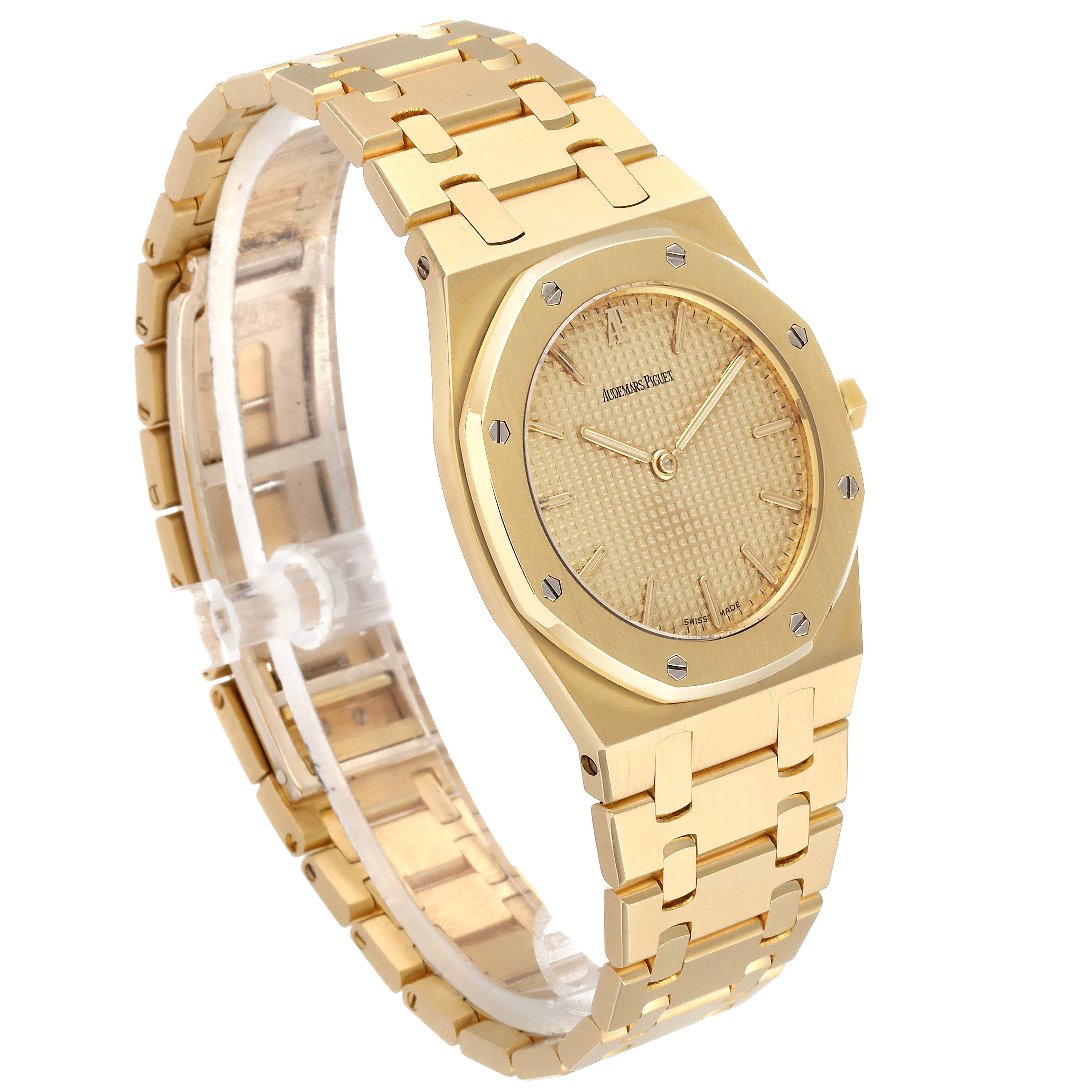 The image shows an Audemars Piguet Royal Oak  Men's Yellow Gold Champagne Dial  Men's Yellow Gold Champagne Dial watch from a three-quarter angle highlighting the bracelet and dial.