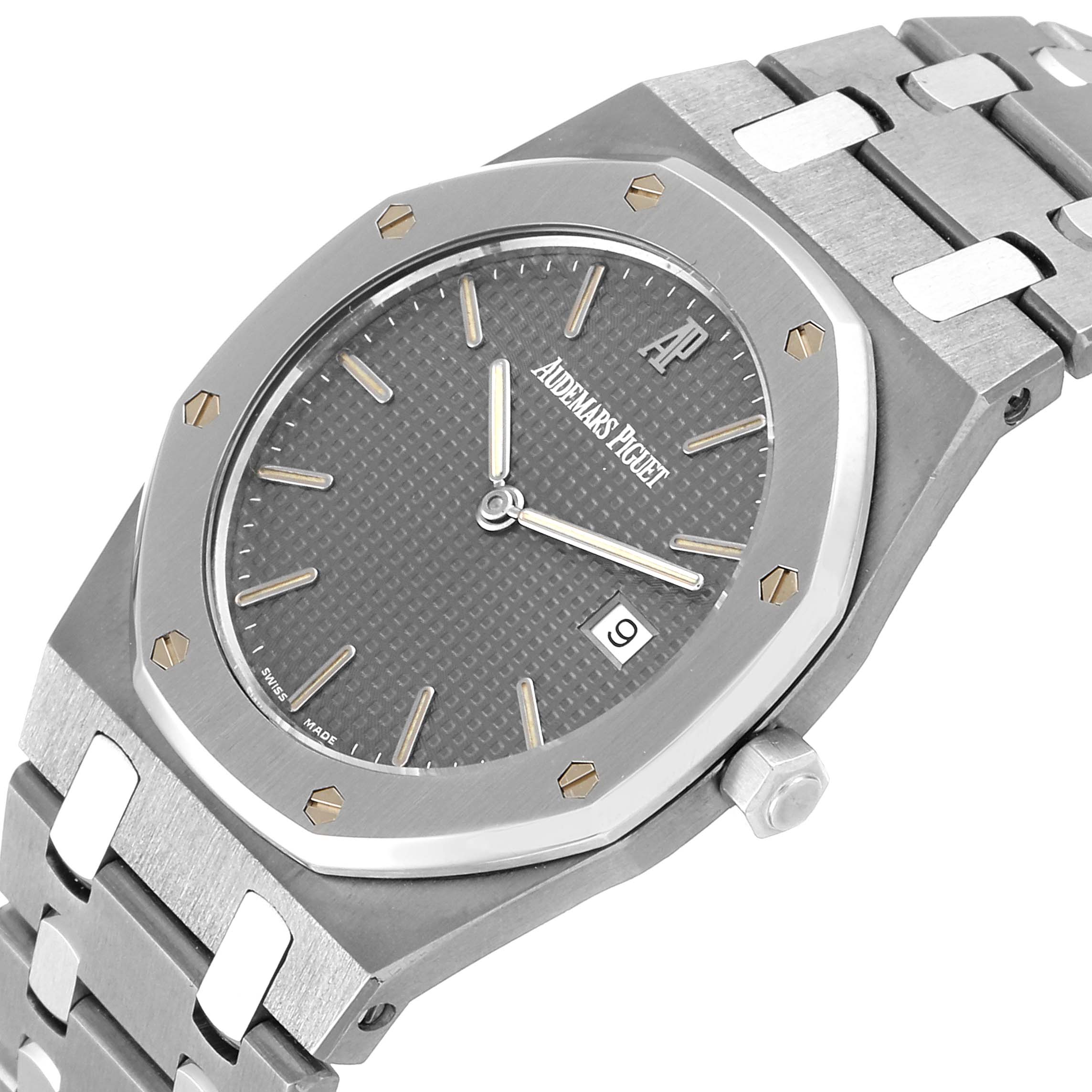 This image shows an Audemars Piguet Royal Oak  Men's Titanium Grey Dial  Men's Titanium Grey Dial watch at a slight angle, highlighting its grey dial, octagonal bezel, and metal bracelet.