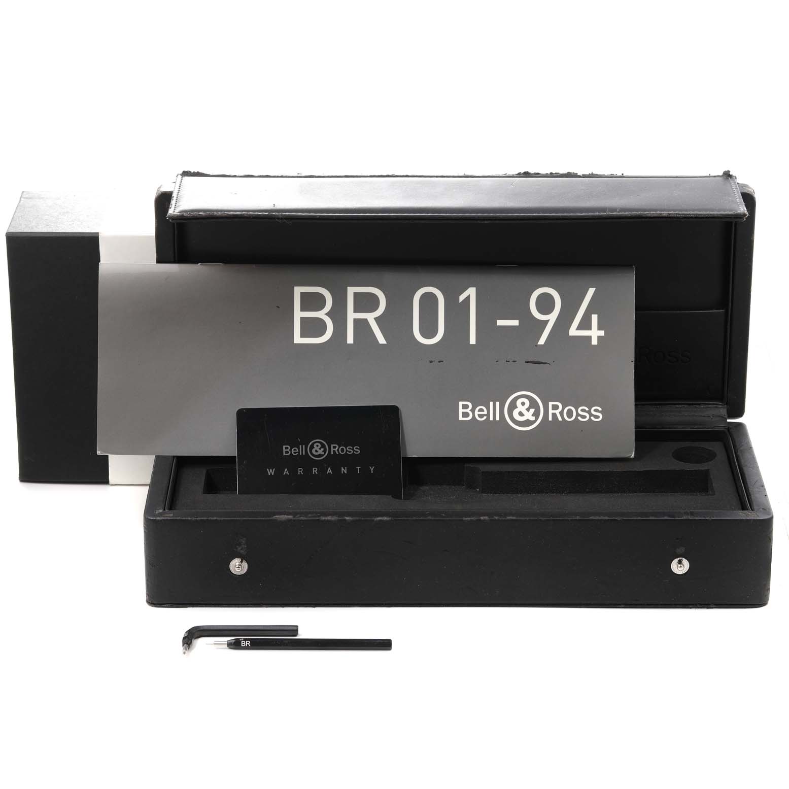 The image shows the packaging, manual, warranty card, and tools for the Bell 
Ross Chronograph BR 01-94 watch.