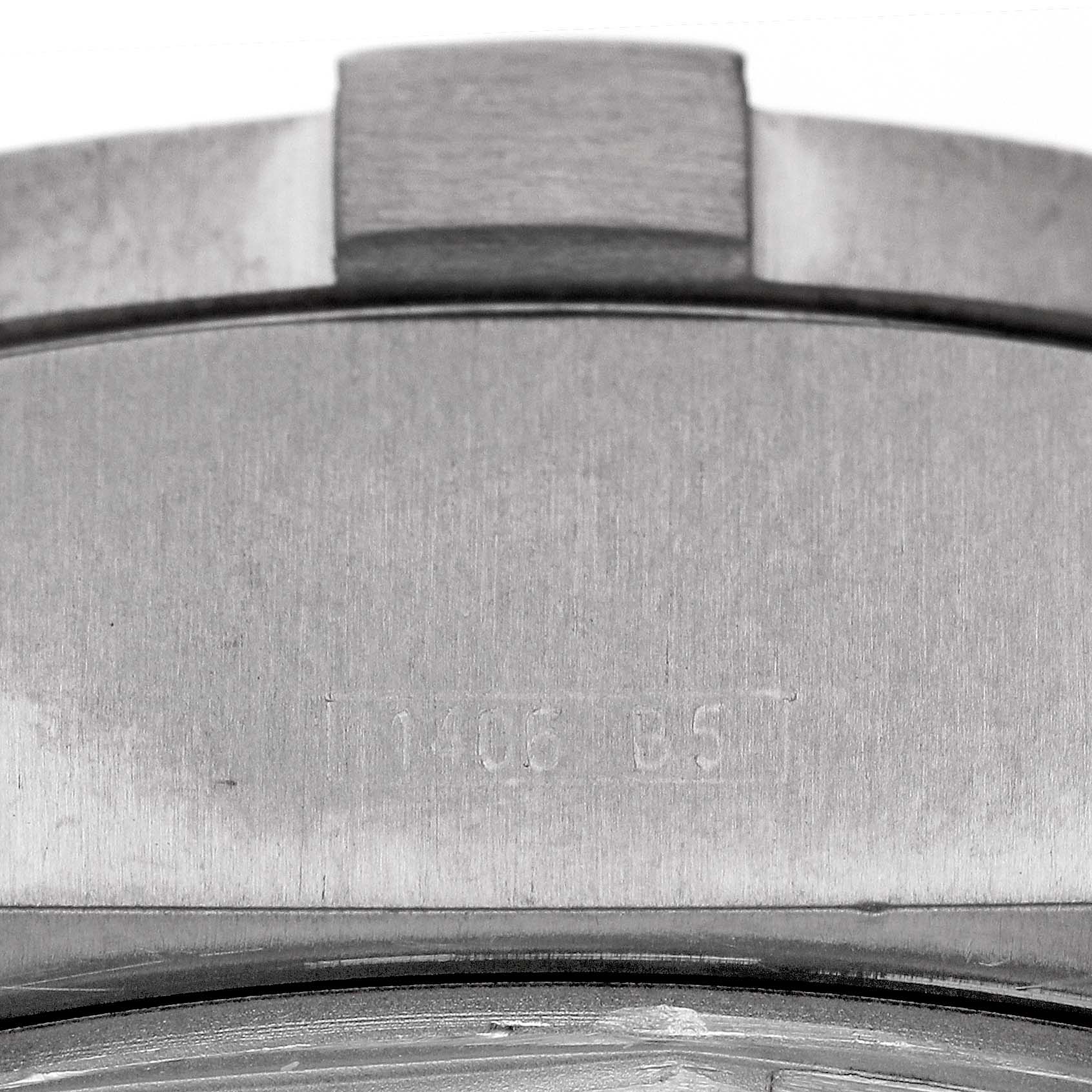 The image shows a close-up of the side and part of the bezel of a Breitling Avenger E73360 Men's Titanium Yellow Dial E73360 Men's Titanium Yellow Dial watch, highlighting its serial number engraving.