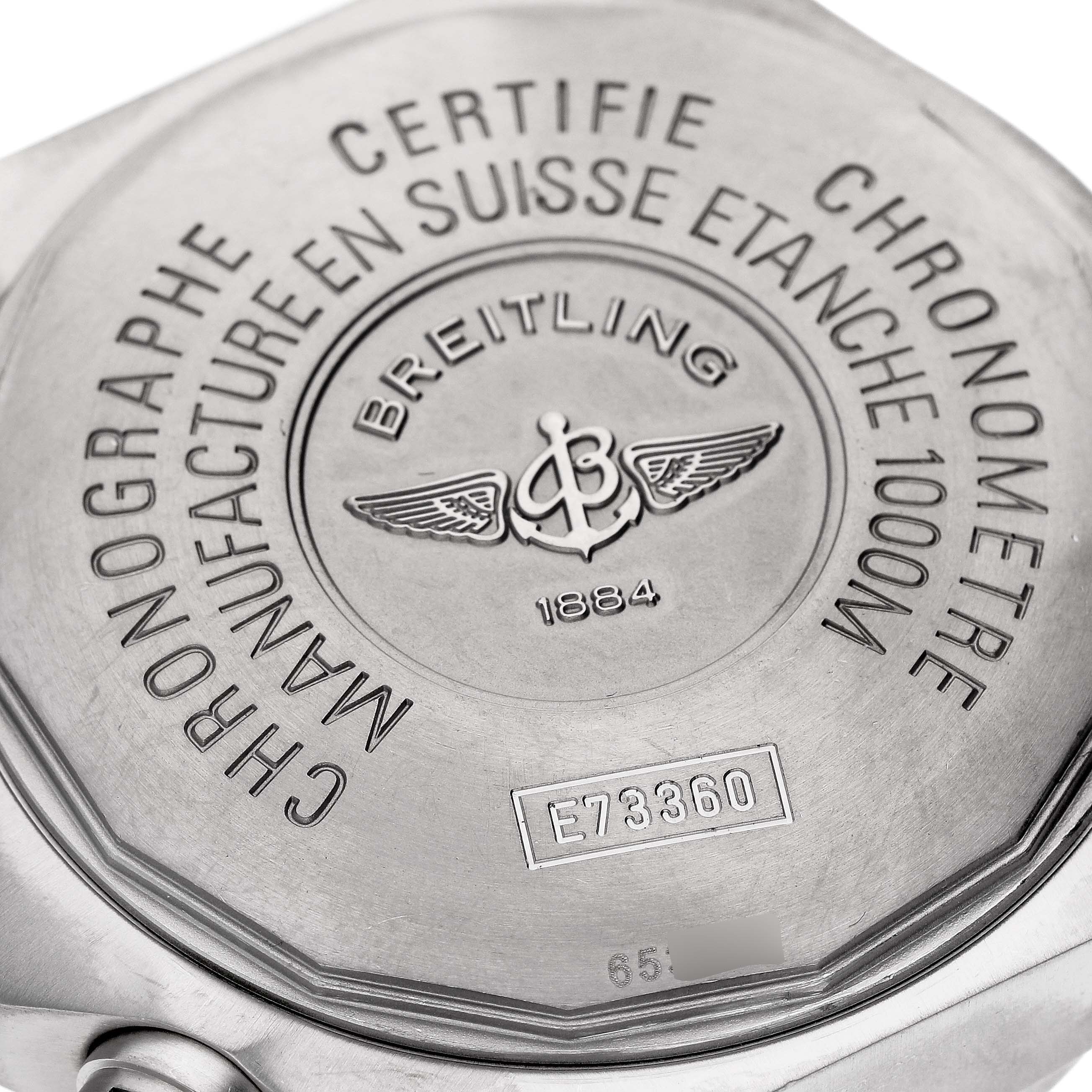 The image shows the back case of the Breitling Avenger E73360 Men's Titanium Yellow Dial E73360 Men's Titanium Yellow Dial watch, highlighting its engraved details and certification marks.