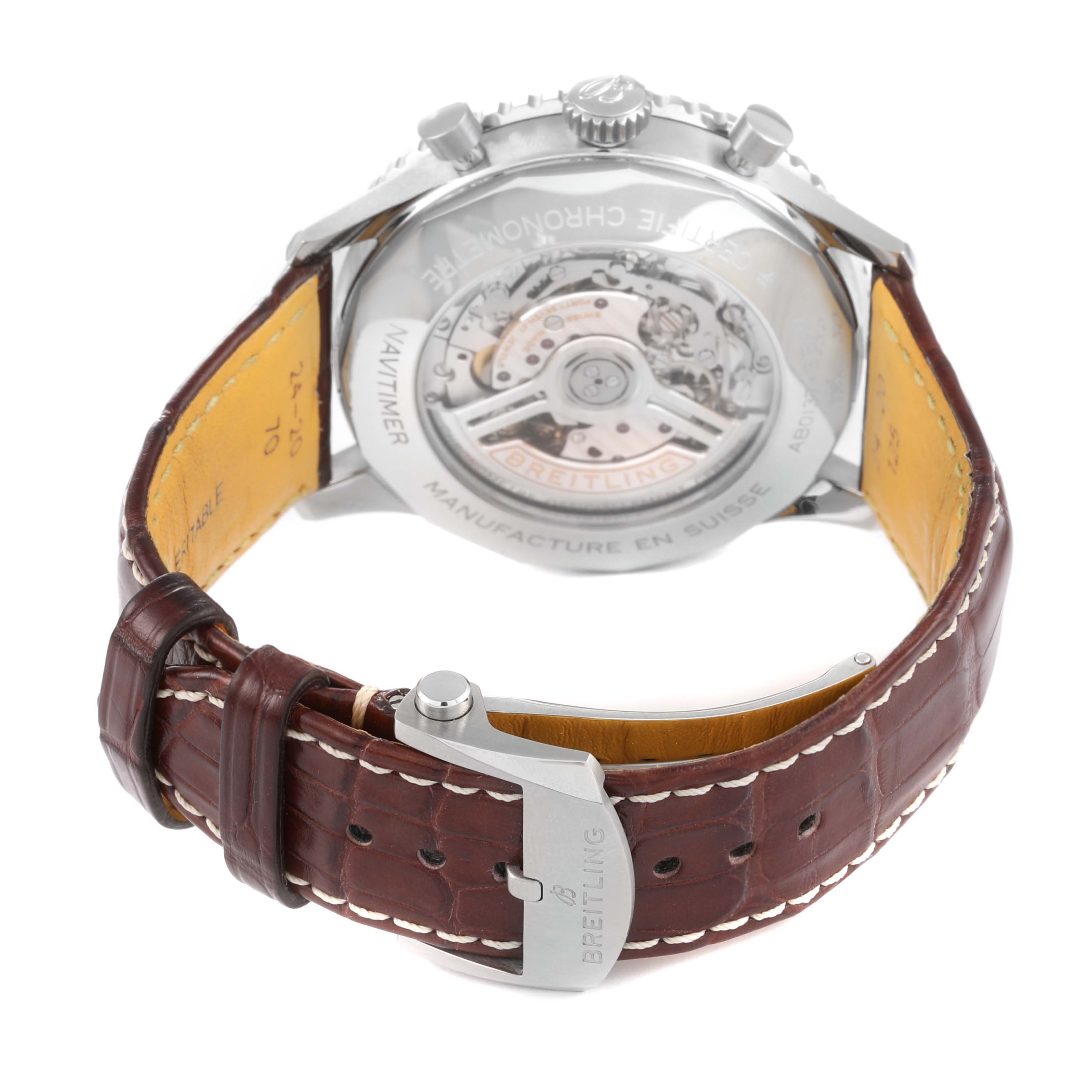 The image shows the back and inner mechanisms of a Breitling Navitimer AB0137 Men
s Stainless Steel Blue Dial AB0137 Men
s Stainless Steel Blue Dial watch, along with its brown leather strap and clasp.