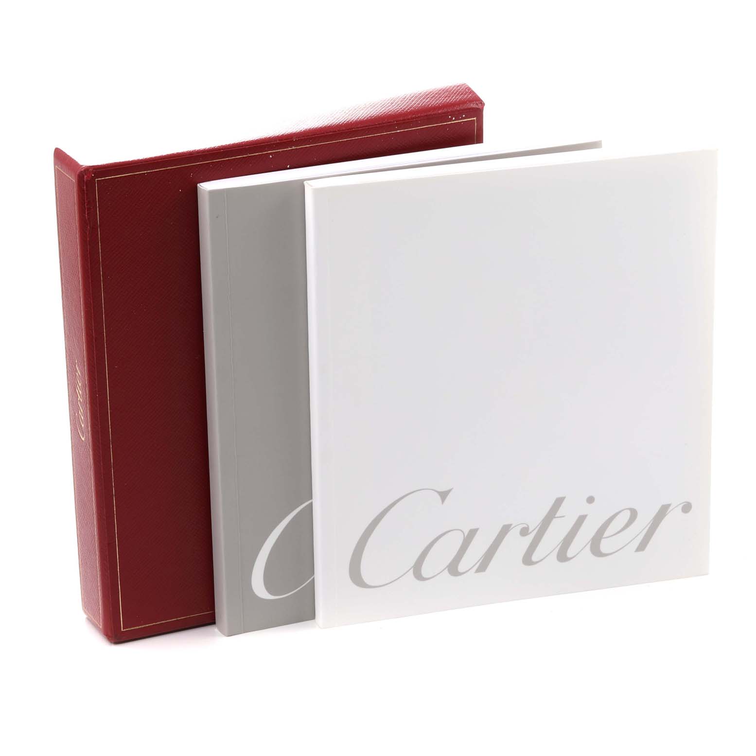 The image shows the packaging and documentation for the Roadster model by Cartier, including a red box and two booklets.