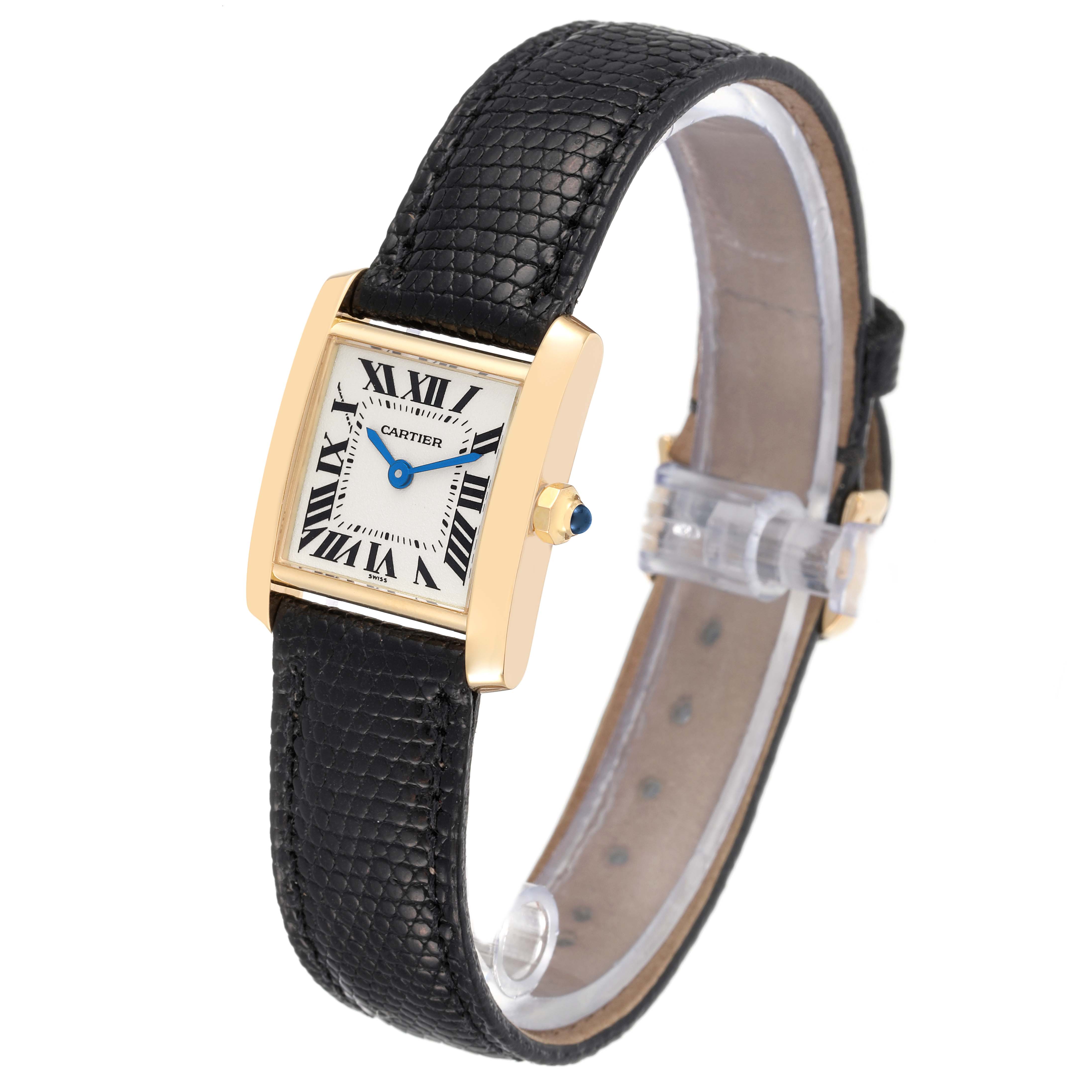 The Cartier Tank Francaise W5000256 Women's Yellow Gold Silver Dial W5000256 Women's Yellow Gold Silver Dial watch is shown at a three-quarter angle, highlighting its gold case and black leather strap.