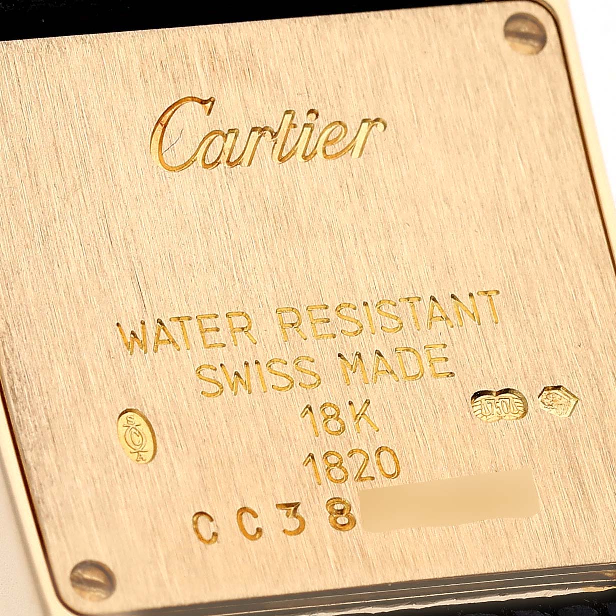 This image shows the back case of a Cartier Tank Française watch, highlighting its inscriptions and markings.