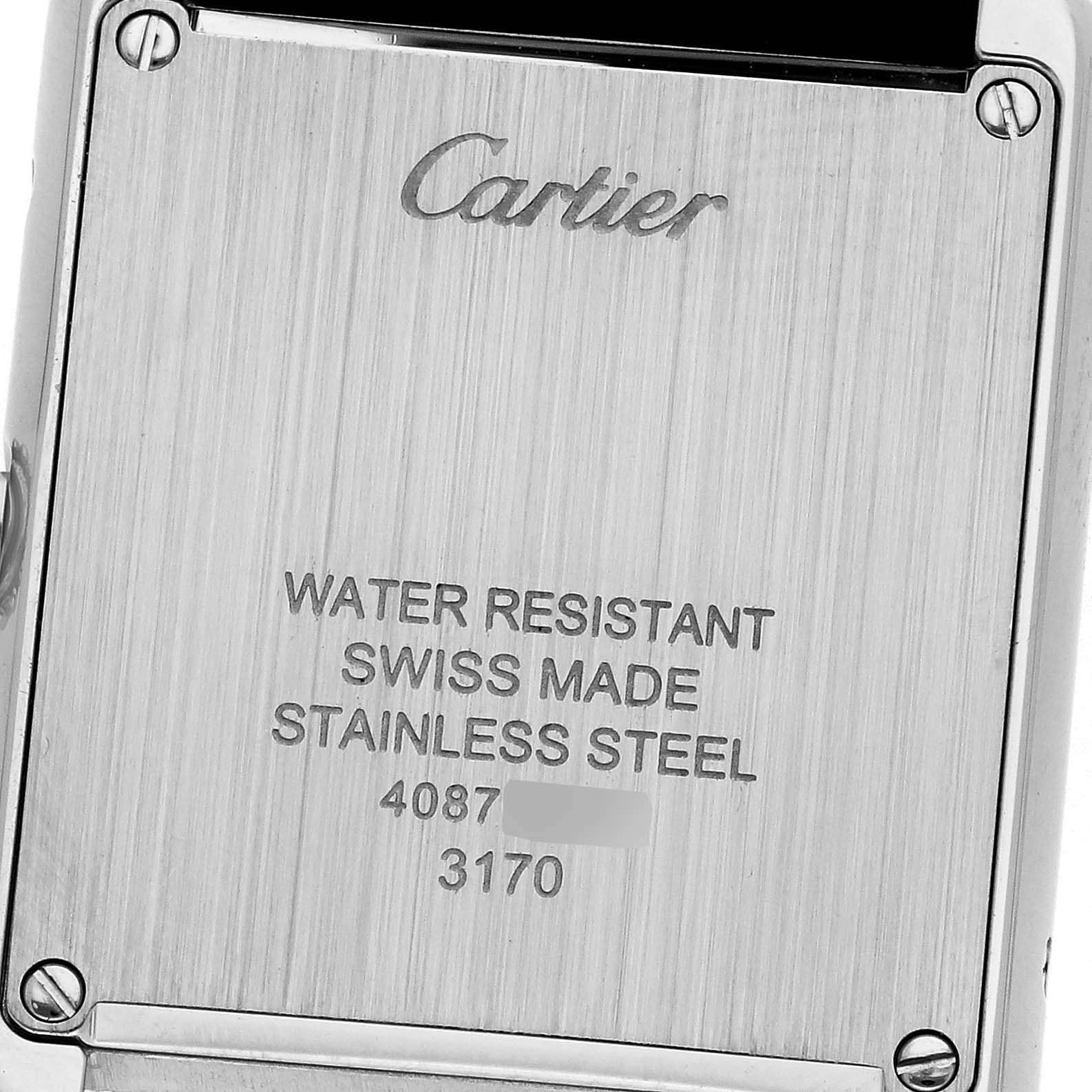 The image shows the back of a Cartier Tank Solo W5200005 Women's Stainless Steel Silver Dial W5200005 Women's Stainless Steel Silver Dial watch, highlighting the engravings and screws.