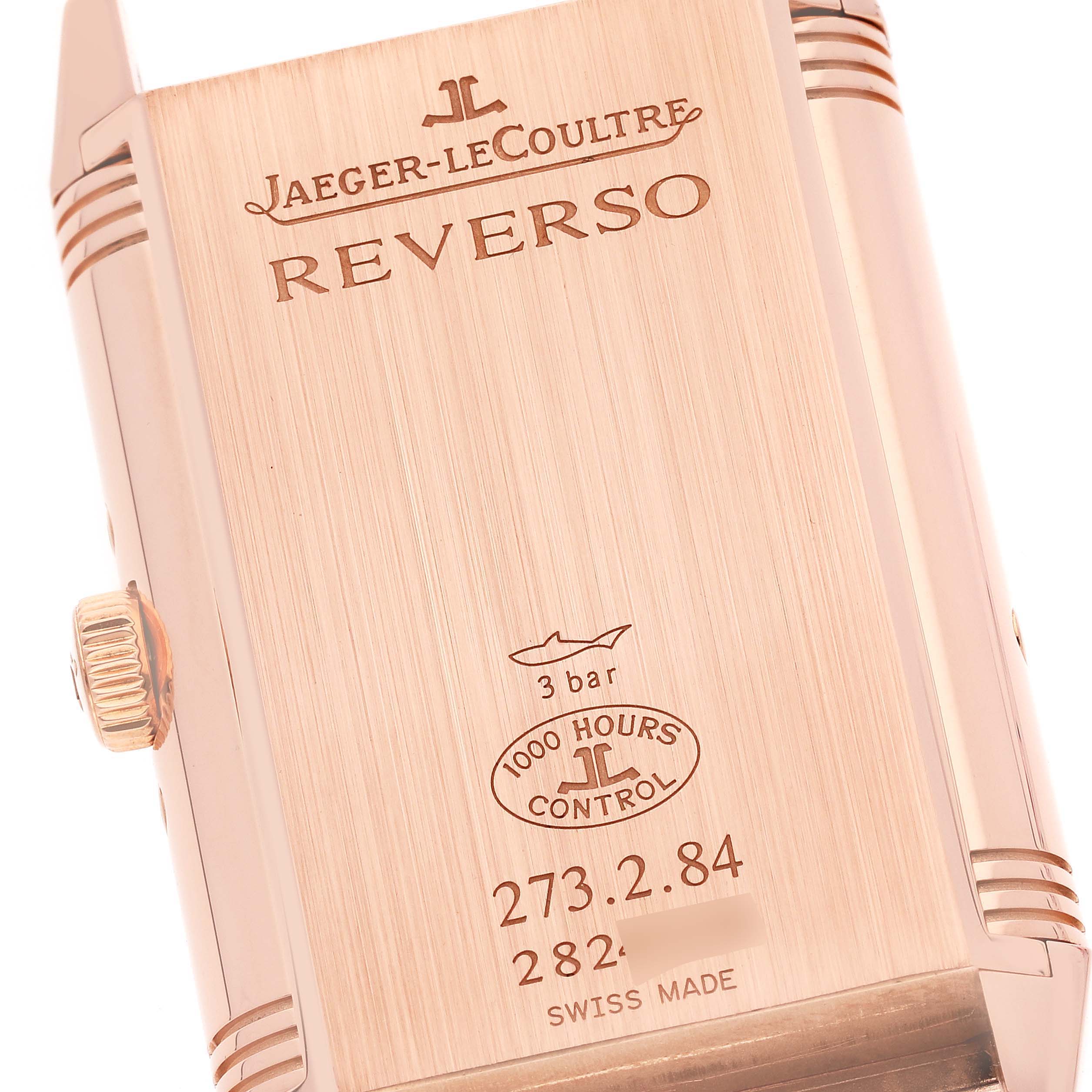This shows the back of a Jaeger-LeCoultre Reverso watch, highlighting the case details, engravings, and the crown on the side.