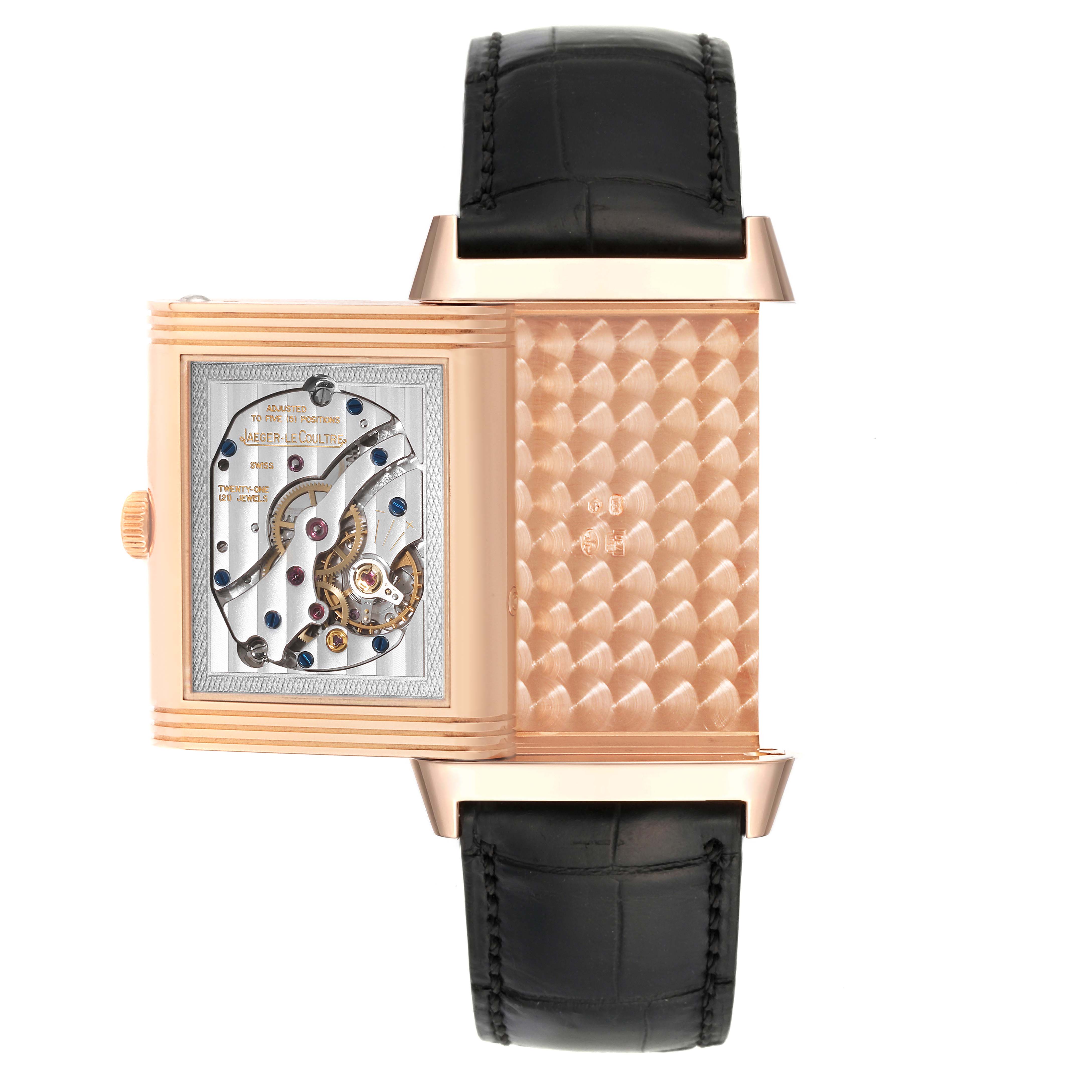 This image shows the back view of a Jaeger-LeCoultre Reverso watch with the case swiveled open, revealing its movement and interior design.