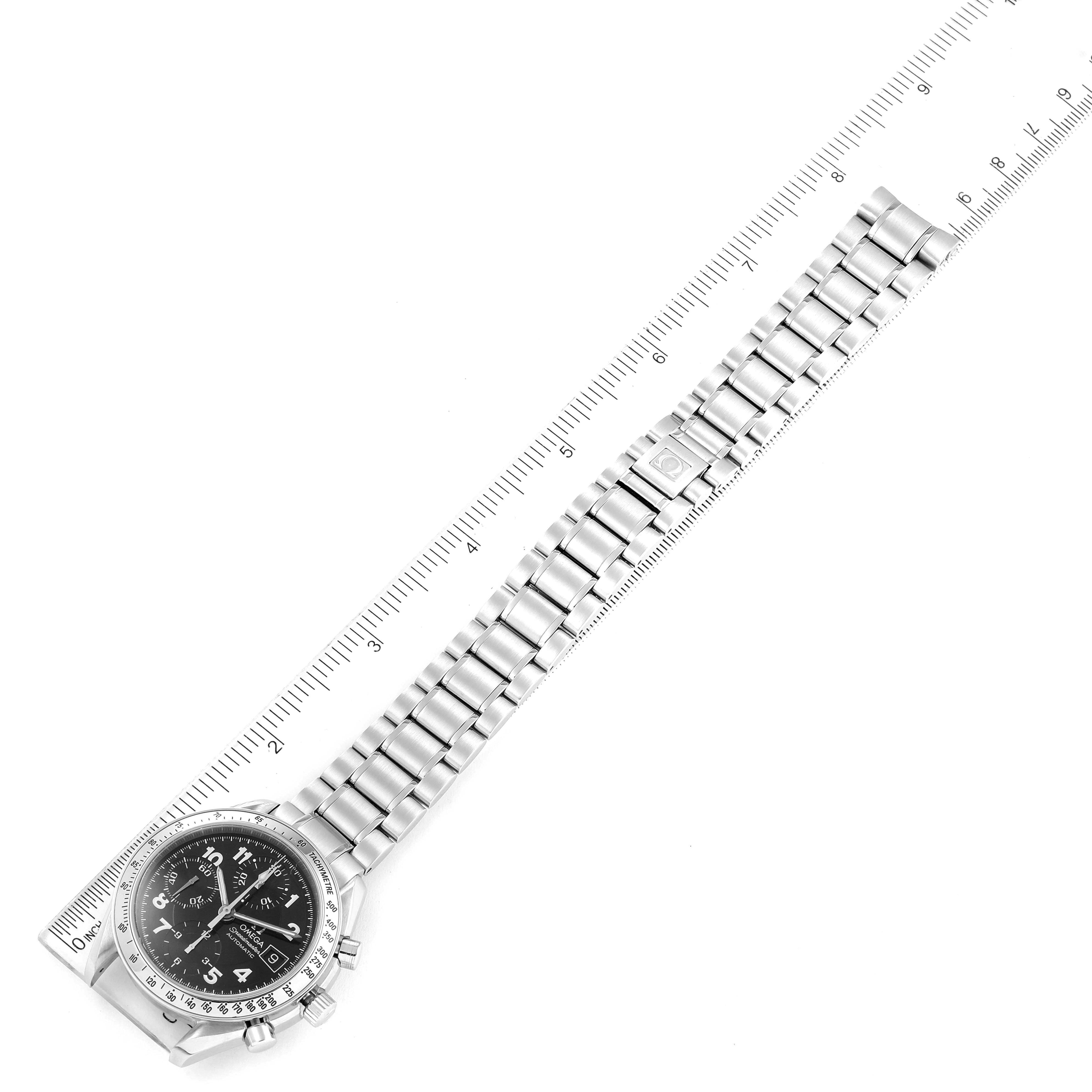 The image shows an Omega Speedmaster 3513.52.00 Men's Stainless Steel Black Dial 3513.52.00 Men's Stainless Steel Black Dial watch laying flat with its stainless steel bracelet measured against a ruler.