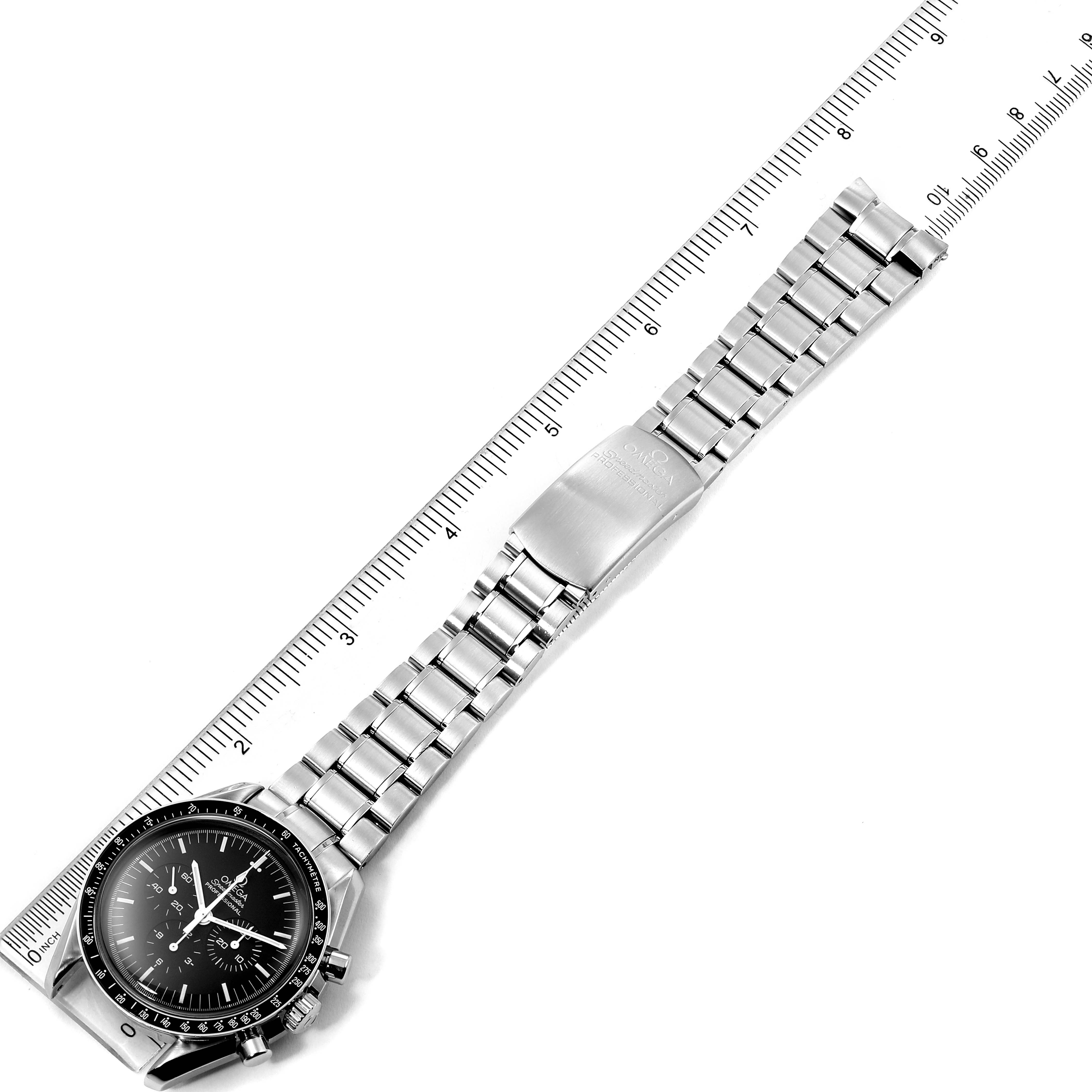 The image shows an Omega Speedmaster 3572.50.00 Men
s Stainless Steel Black Dial 3572.50.00 Men
s Stainless Steel Black Dial watch laid flat alongside a ruler, displaying the case, dial, and full bracelet.