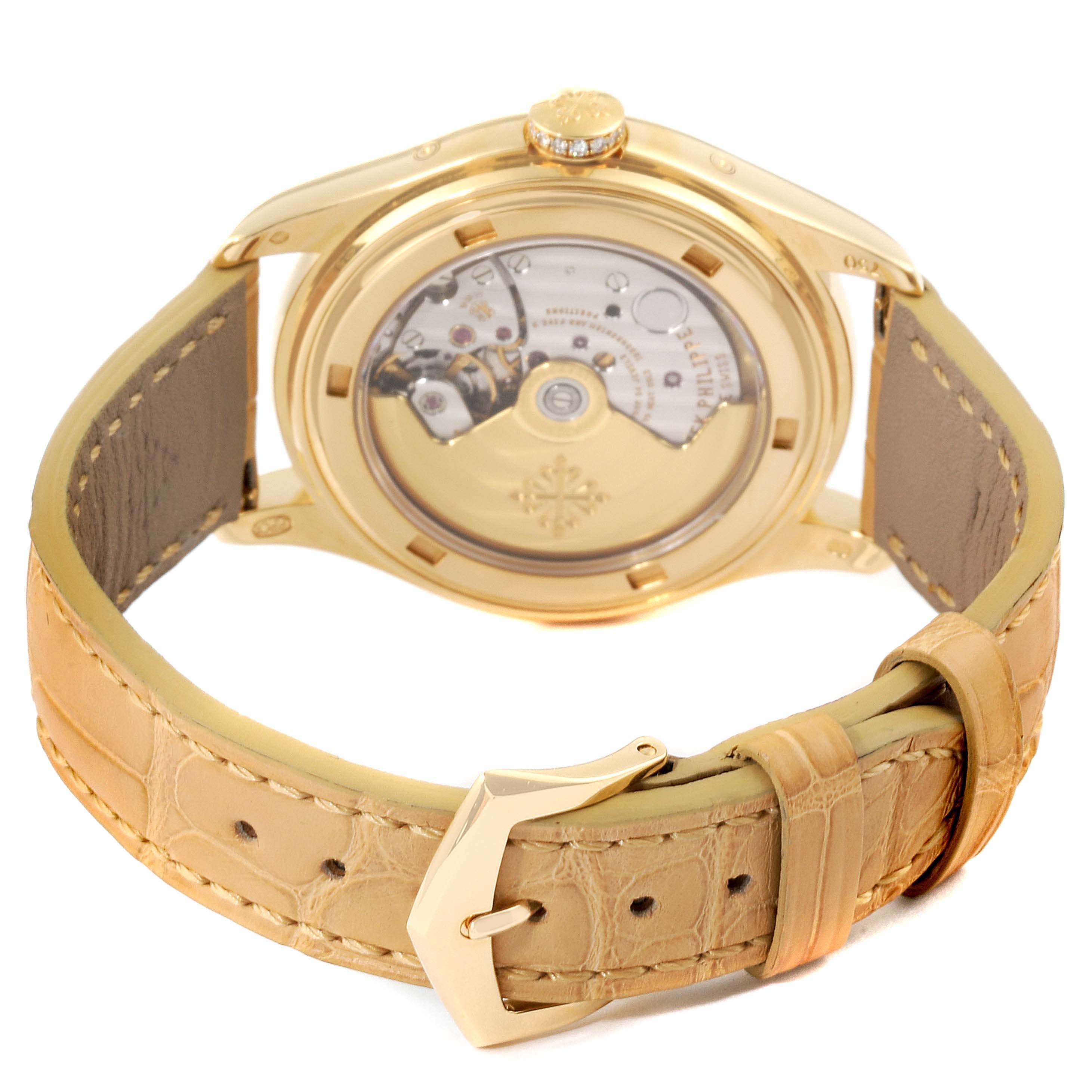 The image shows the back view of the Patek Philippe 4936J Men's Yellow Gold Mother of Pearl Dial 4936J Men's Yellow Gold Mother of Pearl Dial Annual Calendar Yellow Gold MOP Diamond Unisex Watch 4936, highlighting its movement and beige strap.