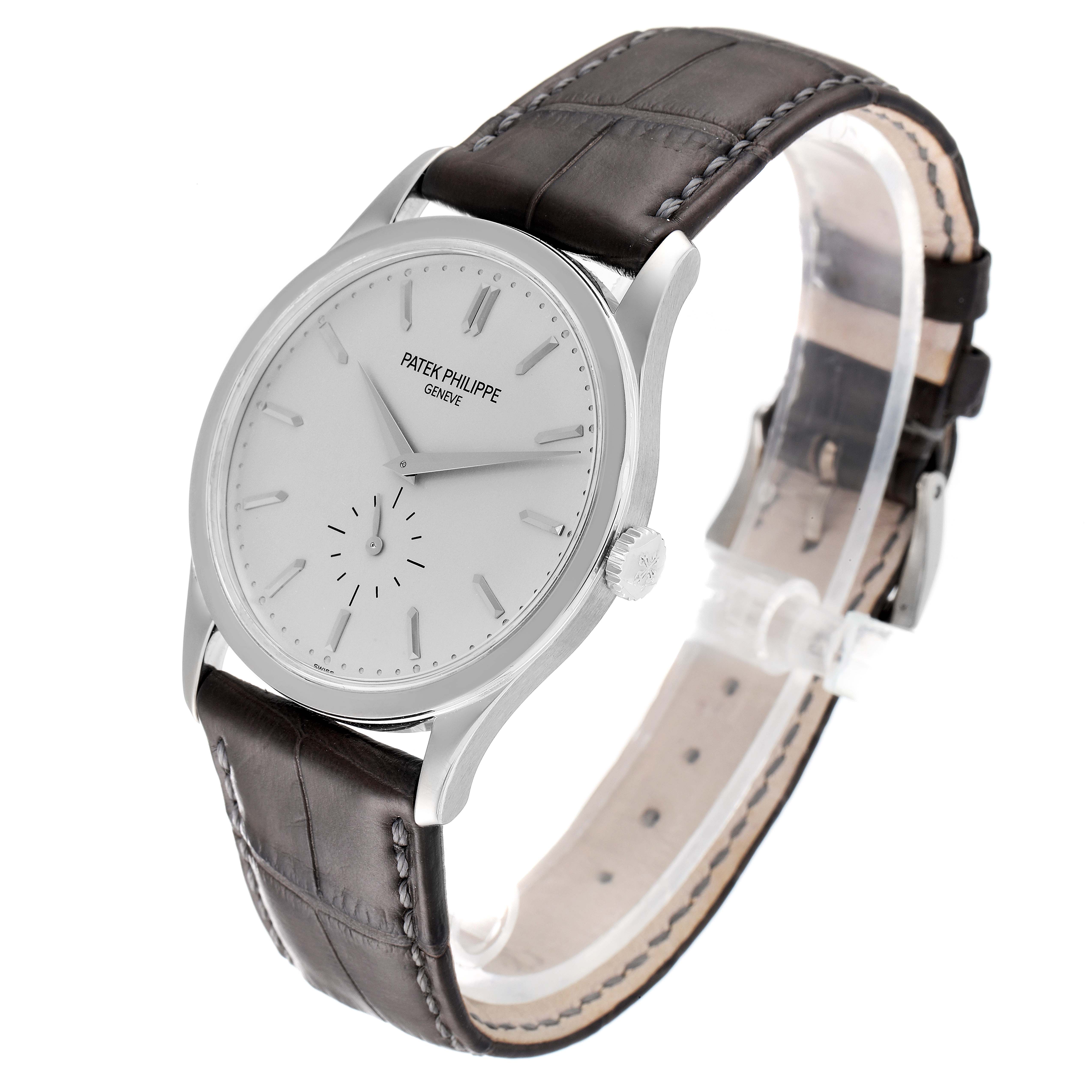 The image shows a side angle view of a Patek Philippe Calatrava 5196G Men's White Gold Silver Dial 5196G Men's White Gold Silver Dial watch, displaying its face, crown, and leather strap.