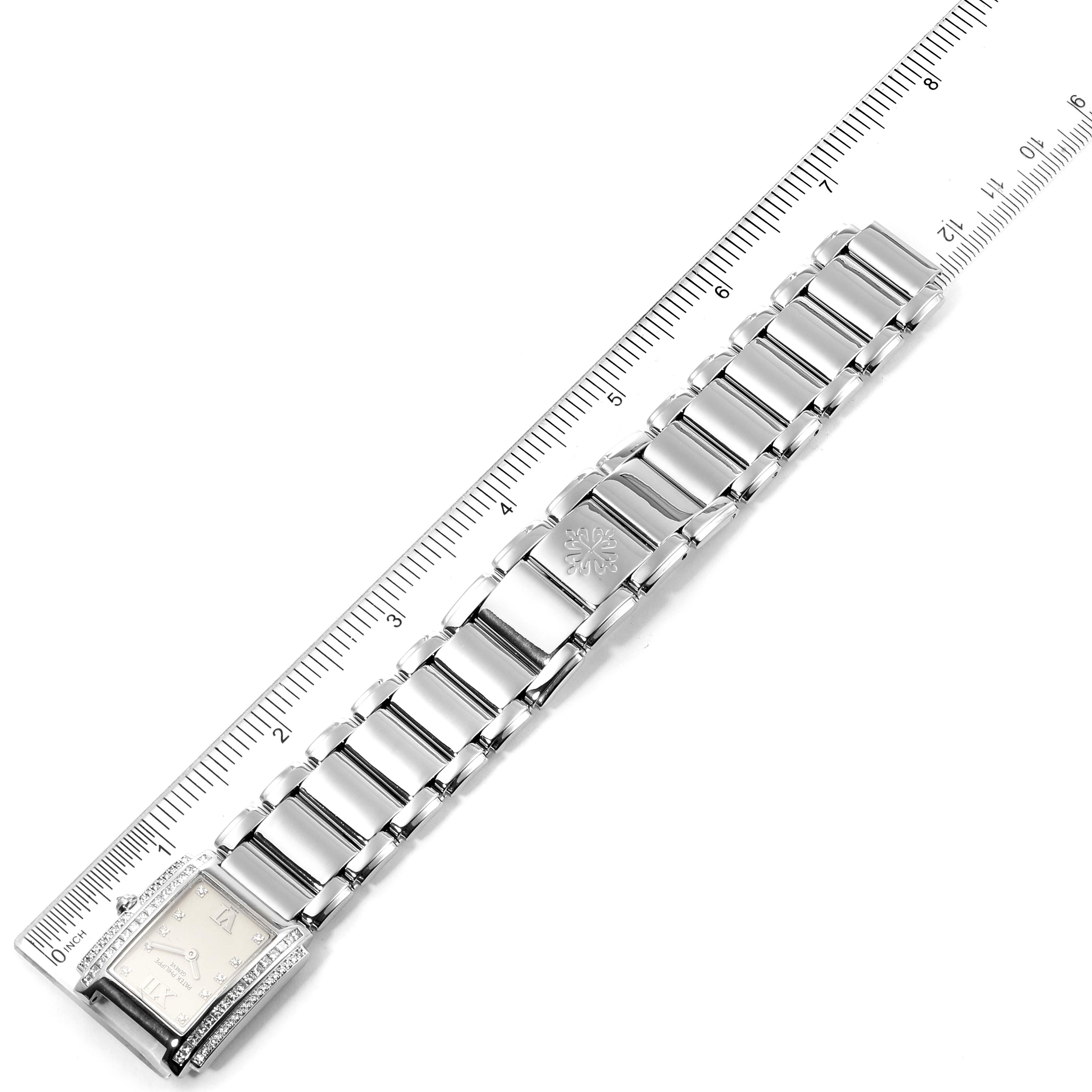 The image shows the full view of the Patek Philippe Twenty-4 4908/310G-011 Women's White Gold Silver Dial 4908/310G-011 Women's White Gold Silver Dial watch with a metal link bracelet, placed alongside a ruler.