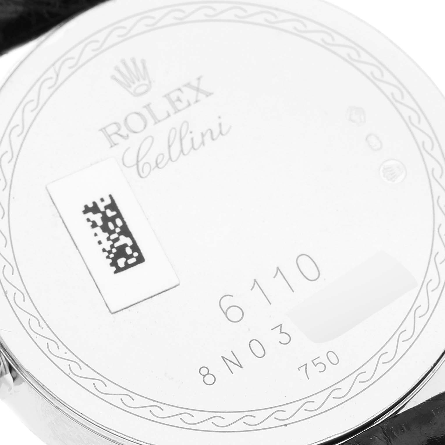 This is a close-up of the back of a Rolex Cellini 6110/9 Women's White Gold White Dial 6110/9 Women's White Gold White Dial watch, showing the model number 6110 and other engravings.