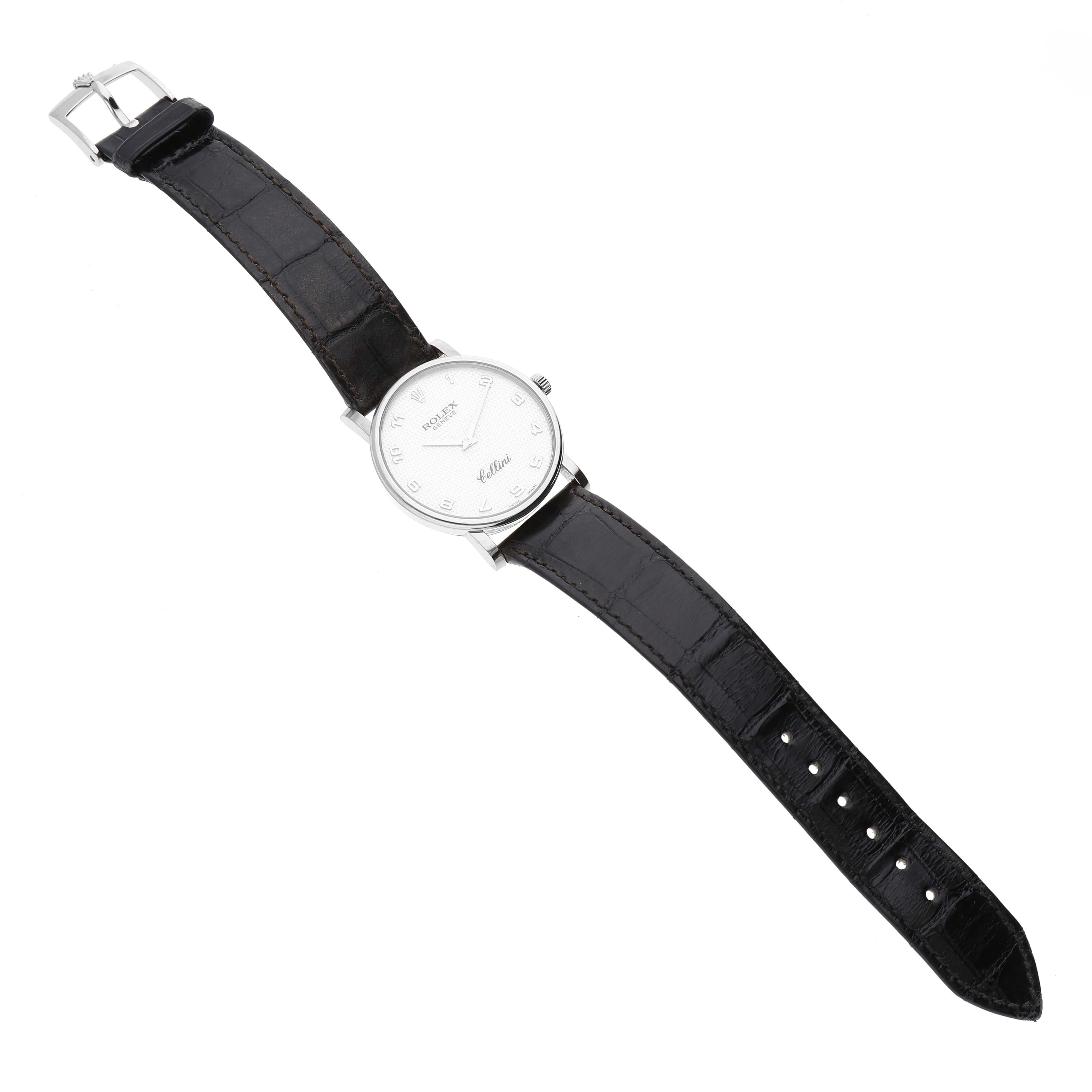 This image shows a top-down view of a Rolex Cellini 5115/9 Men's White Gold Mother of Pearl Dial 5115/9 Men's White Gold Mother of Pearl Dial watch displaying its black leather strap and white dial.