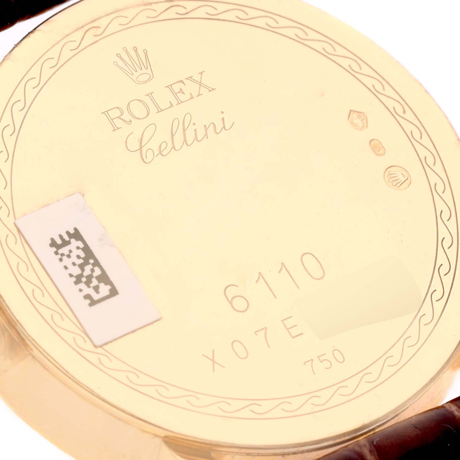 This image shows the backside of a Rolex Cellini 6110/8 Women's Yellow Gold Mother of Pearl Dial 6110/8 Women's Yellow Gold Mother of Pearl Dial watch, highlighting its engravings and serial numbers.