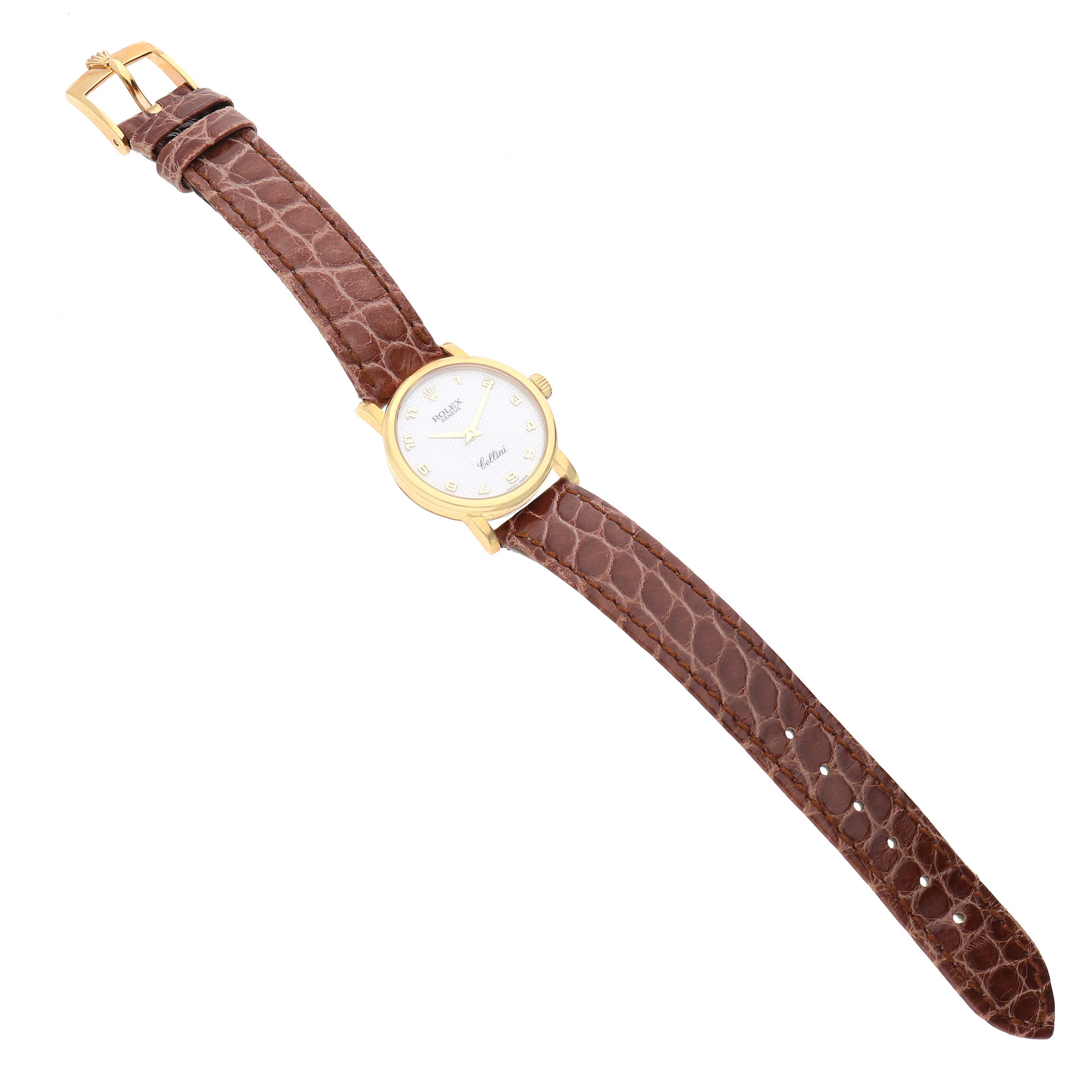 The Rolex Cellini 6110/8 Women's Yellow Gold Mother of Pearl Dial 6110/8 Women's Yellow Gold Mother of Pearl Dial watch is shown from an overhead angle, displaying its face, leather strap, and buckle.