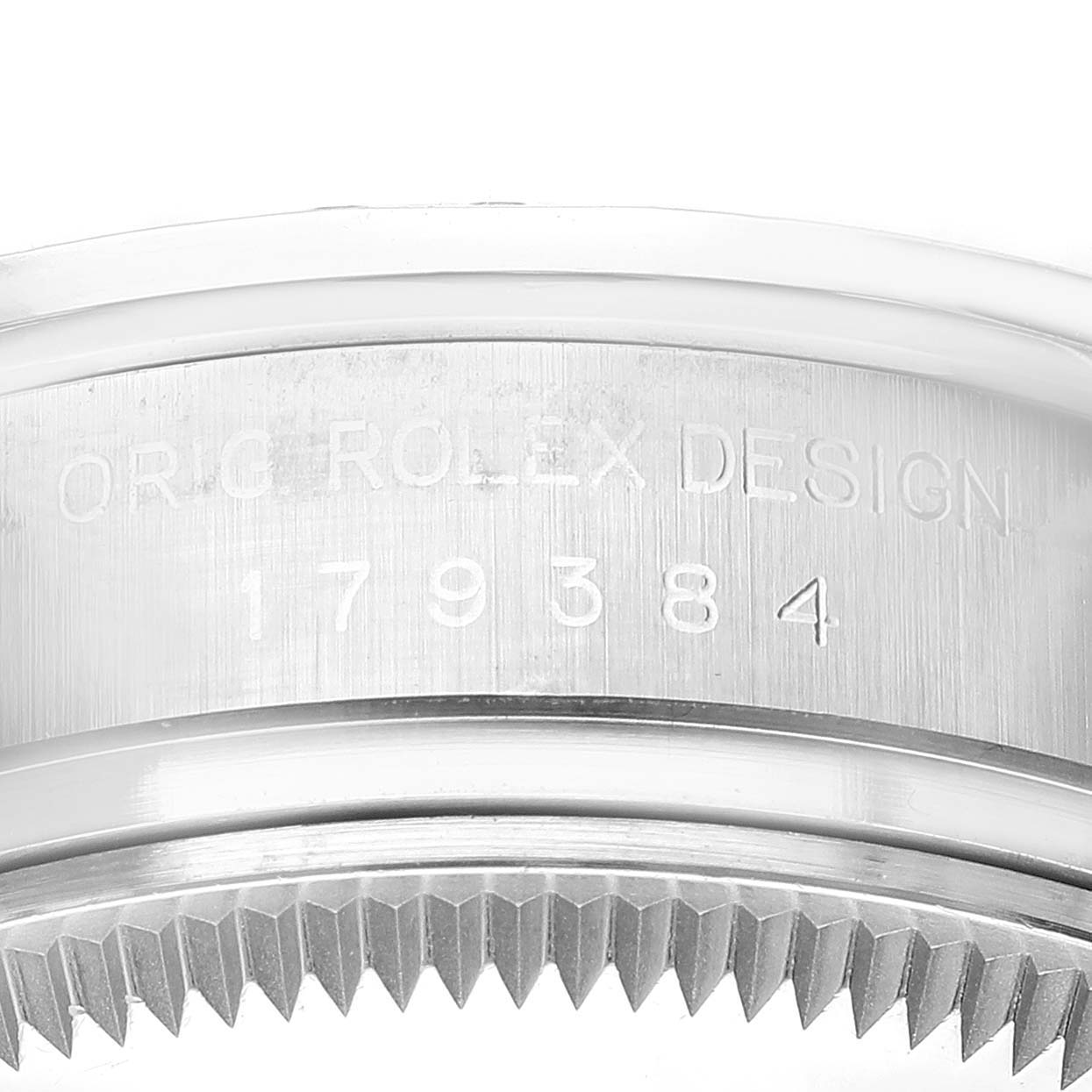 This image shows a close-up of the case side with engraving and part of the bezel teeth on a Rolex Datejust 179384 Women's Stainless Steel Silver Dial 179384 Women's Stainless Steel Silver Dial model.