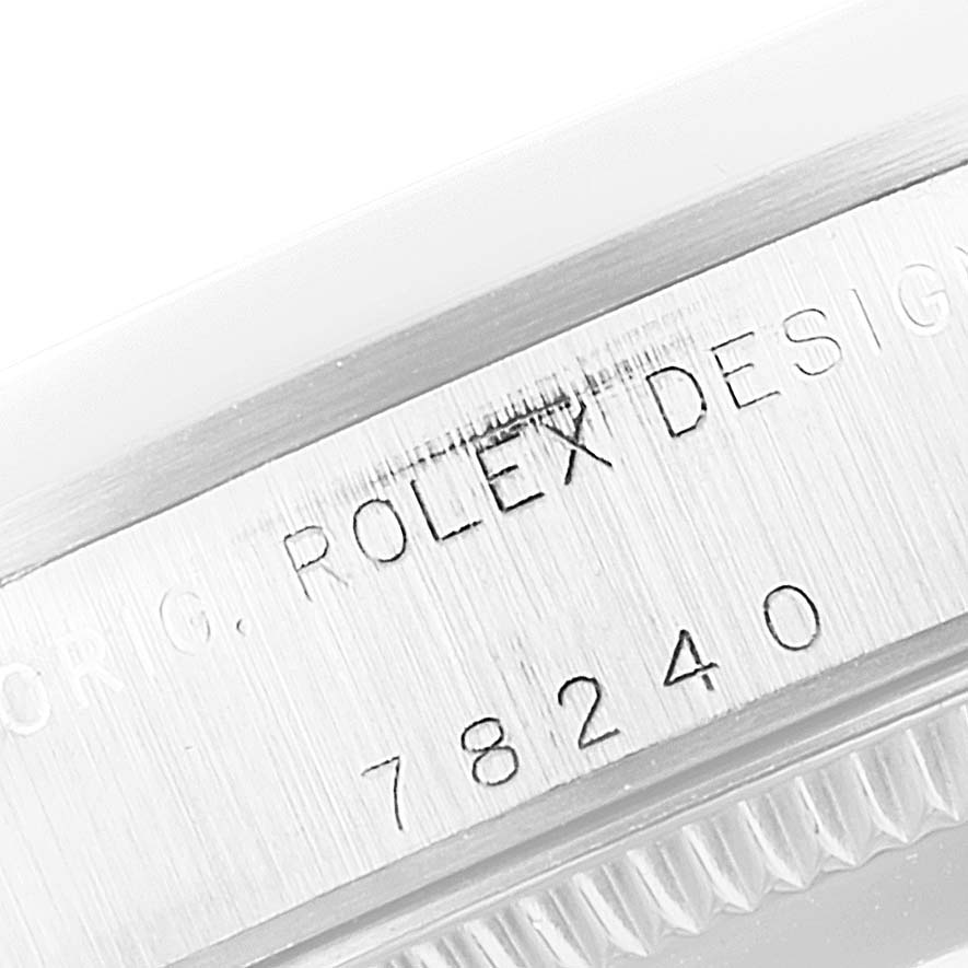 The image shows a close-up of the side engraving on the case of a Rolex Mid-Size 78240 Women
s Stainless Steel Silver Dial 78240 Women
s Stainless Steel Silver Dial model with the inscription "ROLEX DESIGN 78240."
