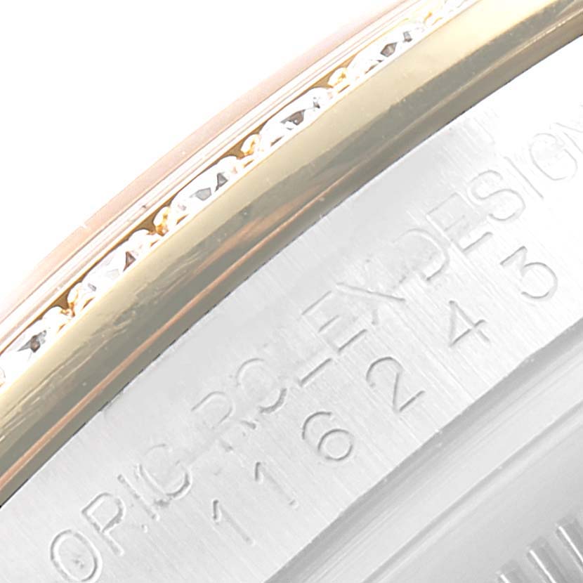 Close-up of the side of a Rolex Datejust 116243 Men's Steel and Gold (two tone) Silver Dial 116243 Men's Steel and Gold (two tone) Silver Dial watch, showing part of the bezel with diamonds and engravings on the case.