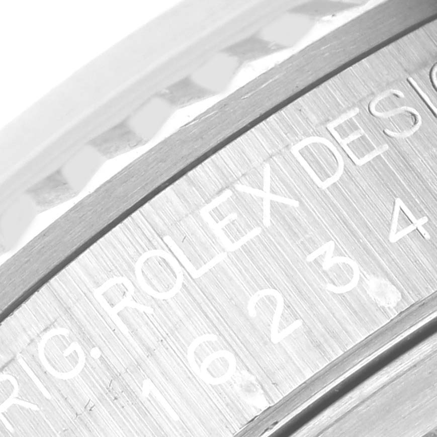 The image shows a close-up of the engraving on the side of a Rolex Datejust 16234 Men's Stainless Steel White Dial 16234 Men's Stainless Steel White Dial model watch case.