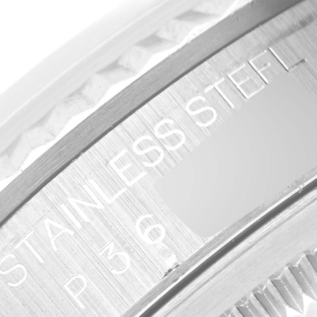 This close-up image shows a portion of the stainless steel casing and engraved text on the Rolex Datejust 16234 Men's Stainless Steel White Dial 16234 Men's Stainless Steel White Dial watch.