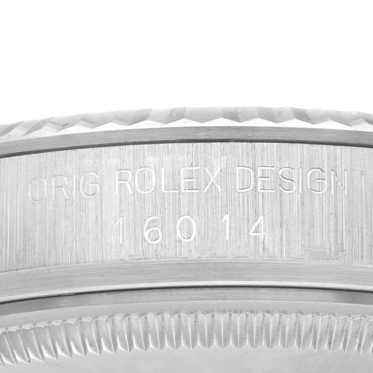 The image shows the side view of a Rolex Datejust 16014 Men's Stainless Steel Silver Dial 16014 Men's Stainless Steel Silver Dial watch, highlighting the engraved bezel with design markings.