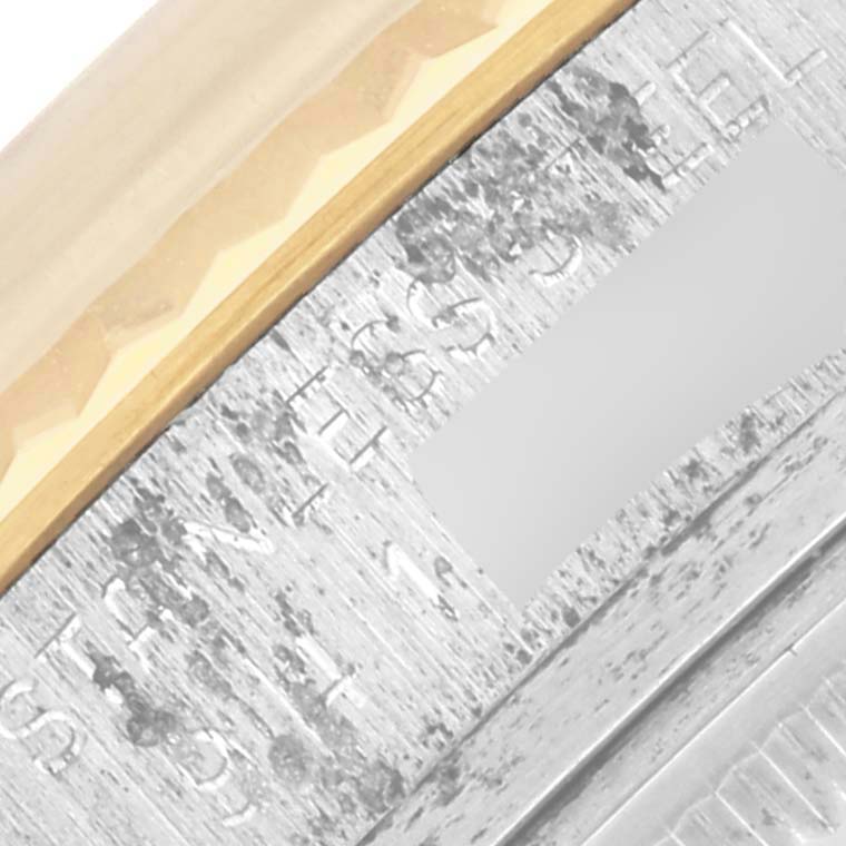 The image shows a close-up of the bezel and engraved part of a Rolex Datejust 16013 Men
s Steel and Gold (two tone) Champagne Dial 16013 Men
s Steel and Gold (two tone) Champagne Dial watch.