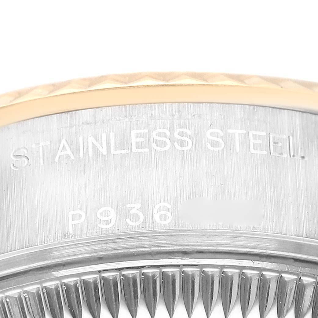 The image shows a close-up of the Rolex Datejust 79173 Women's Steel and Gold (two tone) Blue Dial 79173 Women's Steel and Gold (two tone) Blue Dial's fluted bezel and part of the stainless steel casing with engravings.