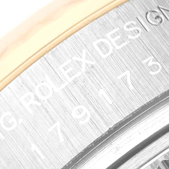 The image shows a close-up of the engraved text on the side of the Rolex Datejust 179173 Women's Steel and Gold (two tone) Blue Dial 179173 Women's Steel and Gold (two tone) Blue Dial model watch bezel.