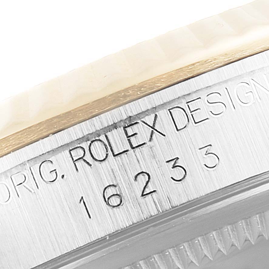 The image shows a close-up view of the engraved case side of a Rolex Datejust 16233 Men
s Steel and Gold (two tone) Grey Dial 16233 Men
s Steel and Gold (two tone) Grey Dial model, displaying its serial number.