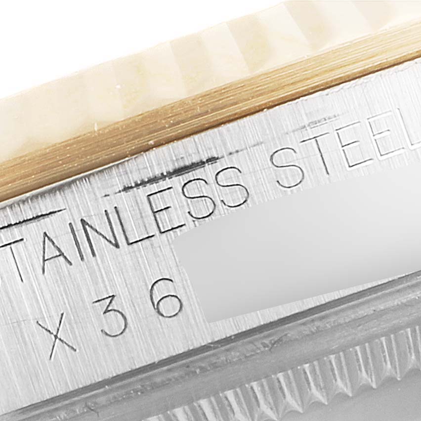 This close-up image shows the engraved details on the side of the bezel of a Rolex Datejust 16233 Men's Steel and Gold (two tone) White Dial 16233 Men's Steel and Gold (two tone) White Dial watch.