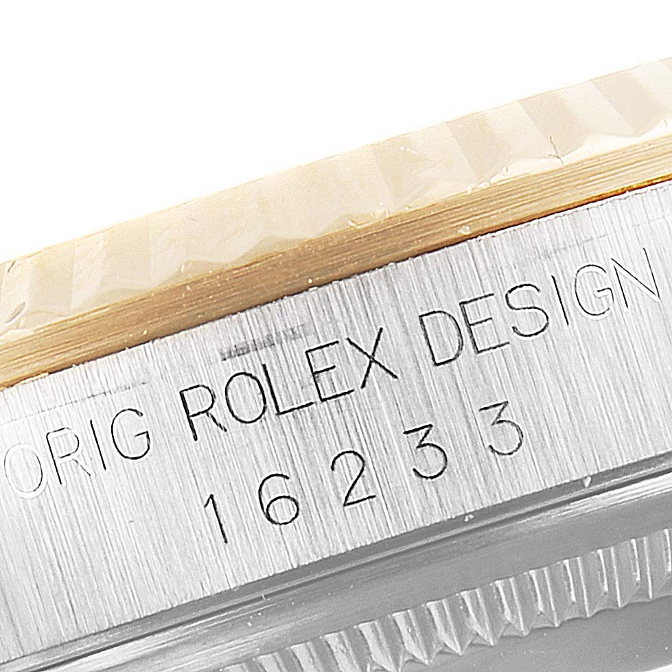 The image shows a close-up view of the side engraving on a Rolex Datejust 16233 Men's Steel and Gold (two tone) White Dial 16233 Men's Steel and Gold (two tone) White Dial model, highlighting the serial number and design details.
