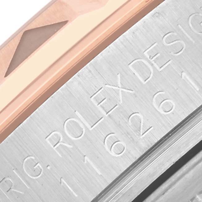 The image shows a close-up of the bezel and engraved side of a Rolex Turn-o-Graph 116261 Men's Steel and Gold (two tone) Black Dial 116261 Men's Steel and Gold (two tone) Black Dial watch.