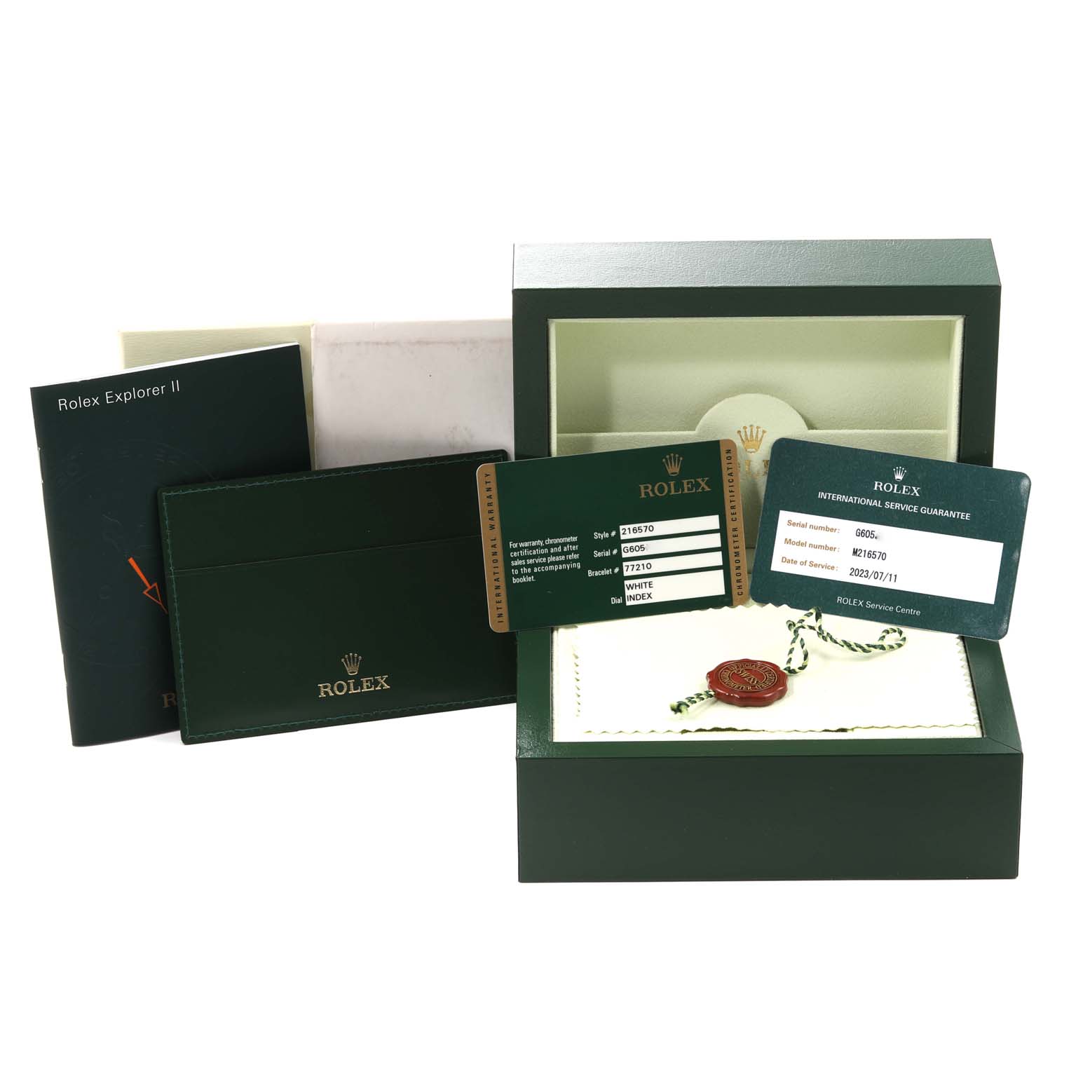 The image shows accessories for a Rolex Explorer 216570 Men's Stainless Steel White Dial 216570 Men's Stainless Steel White Dial model, including a box, booklet, warranty card, and tag.