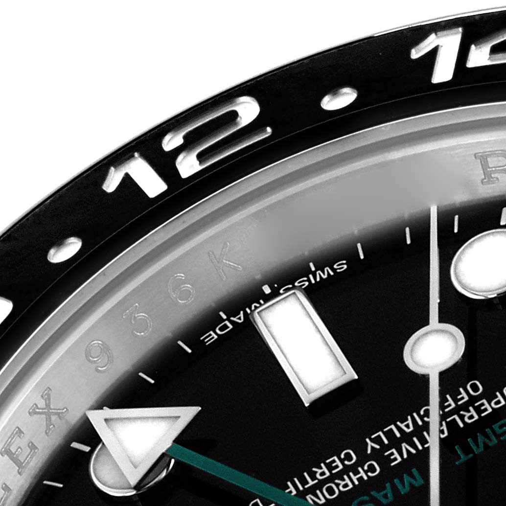 The image shows a close-up of the Rolex GMT-Master 116710LN Men
s Stainless Steel Black Dial 116710LN Men
s Stainless Steel Black Dial
s bezel, dial, and part of the hands at an angle highlighting the 12 o
clock mark.
