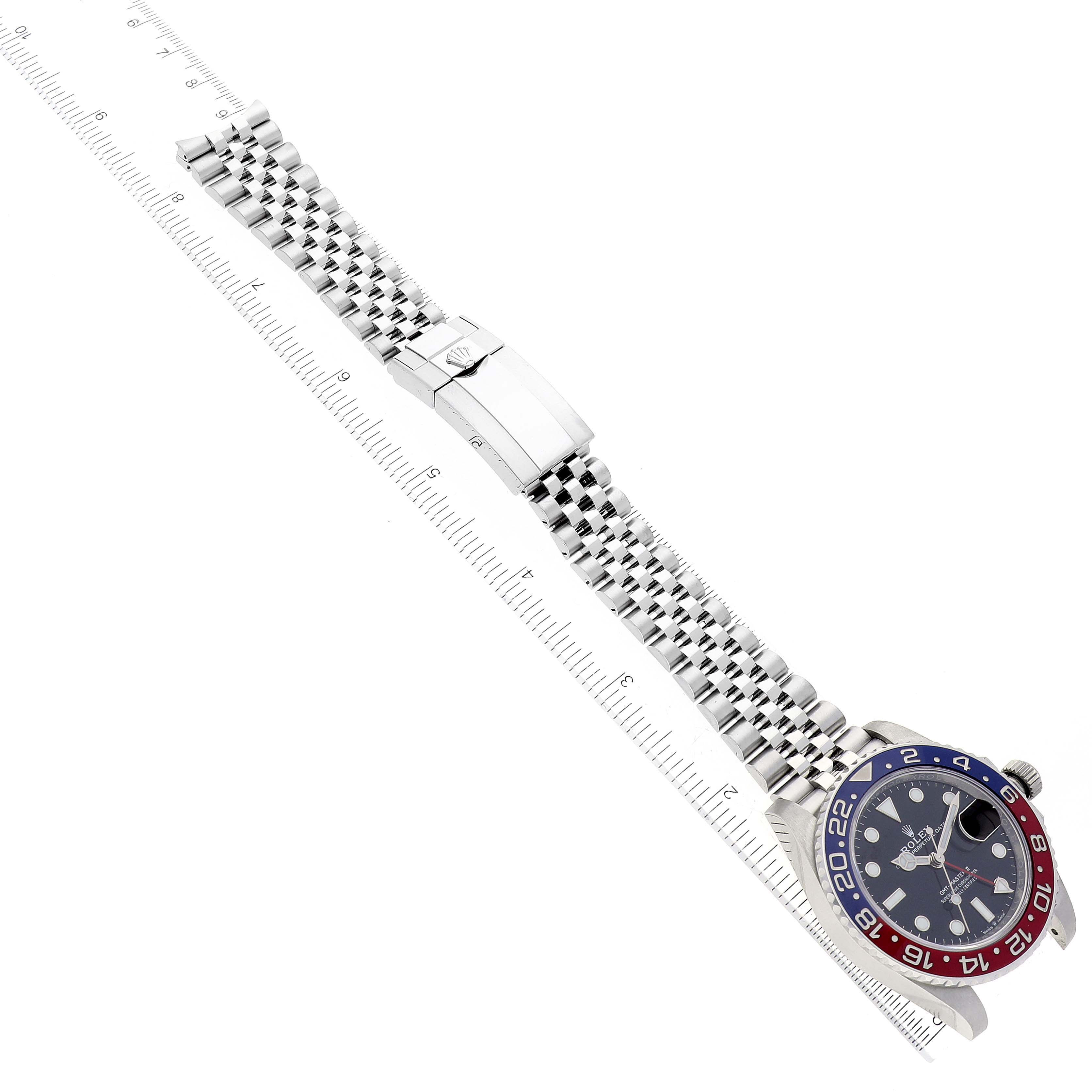 The Rolex GMT-Master 126710BLRO Men
s Stainless Steel Black Dial 126710BLRO Men
s Stainless Steel Black Dial watch is shown at an angle with the face, bezel, bracelet, and clasp visible alongside a ruler.